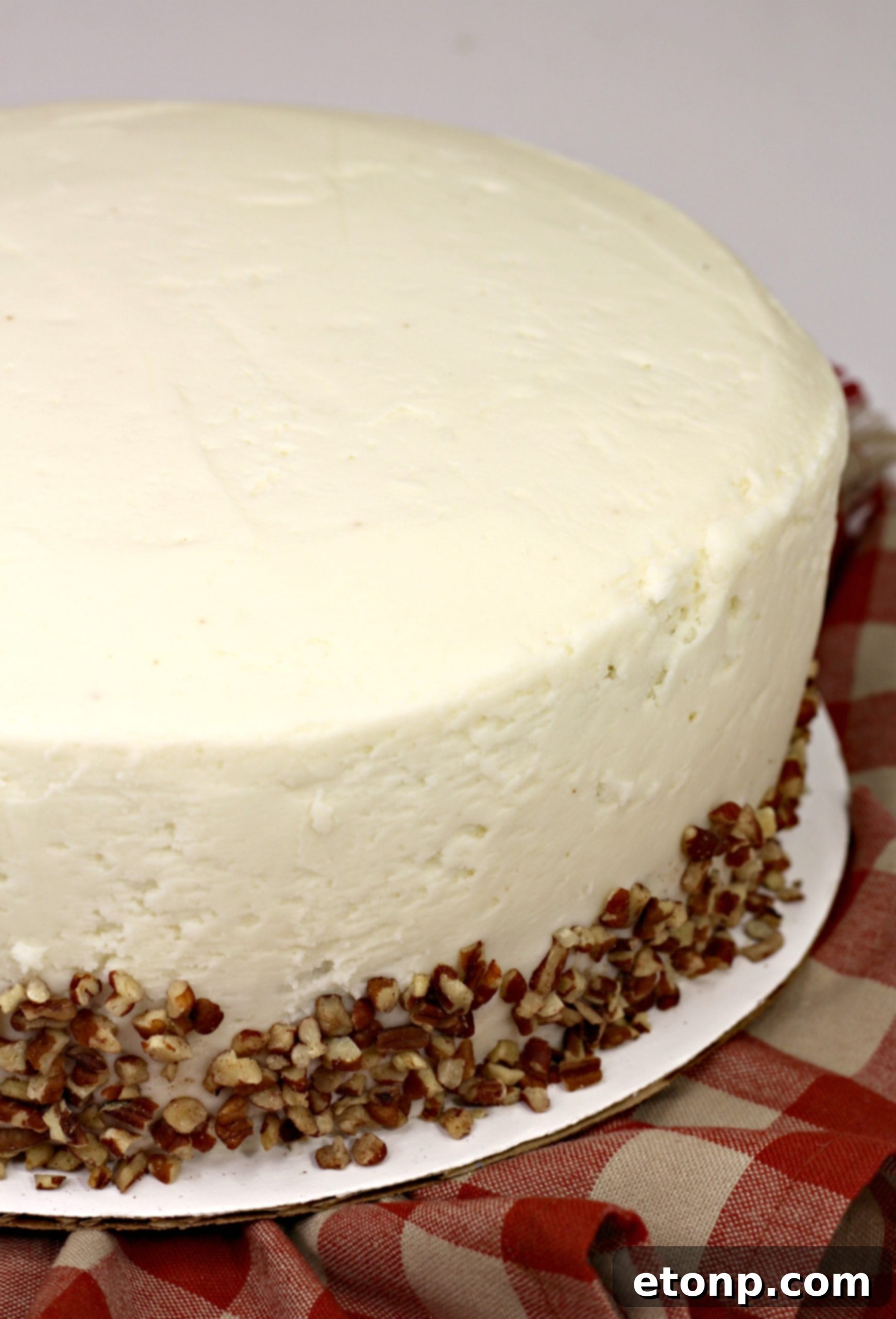 Carrot cake decorated with pecans, ready to be served.