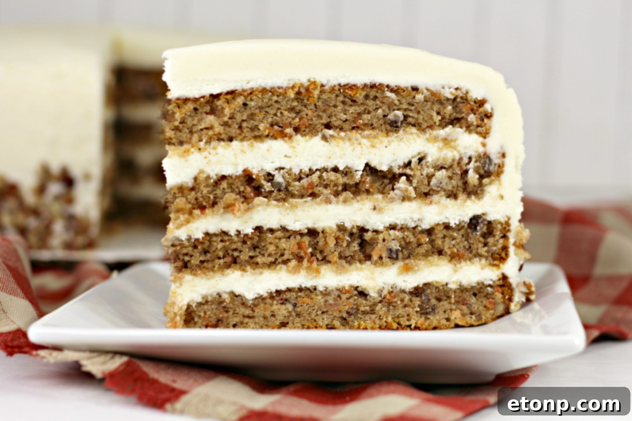 Carrot cake slices showing the rich layers and frosting.