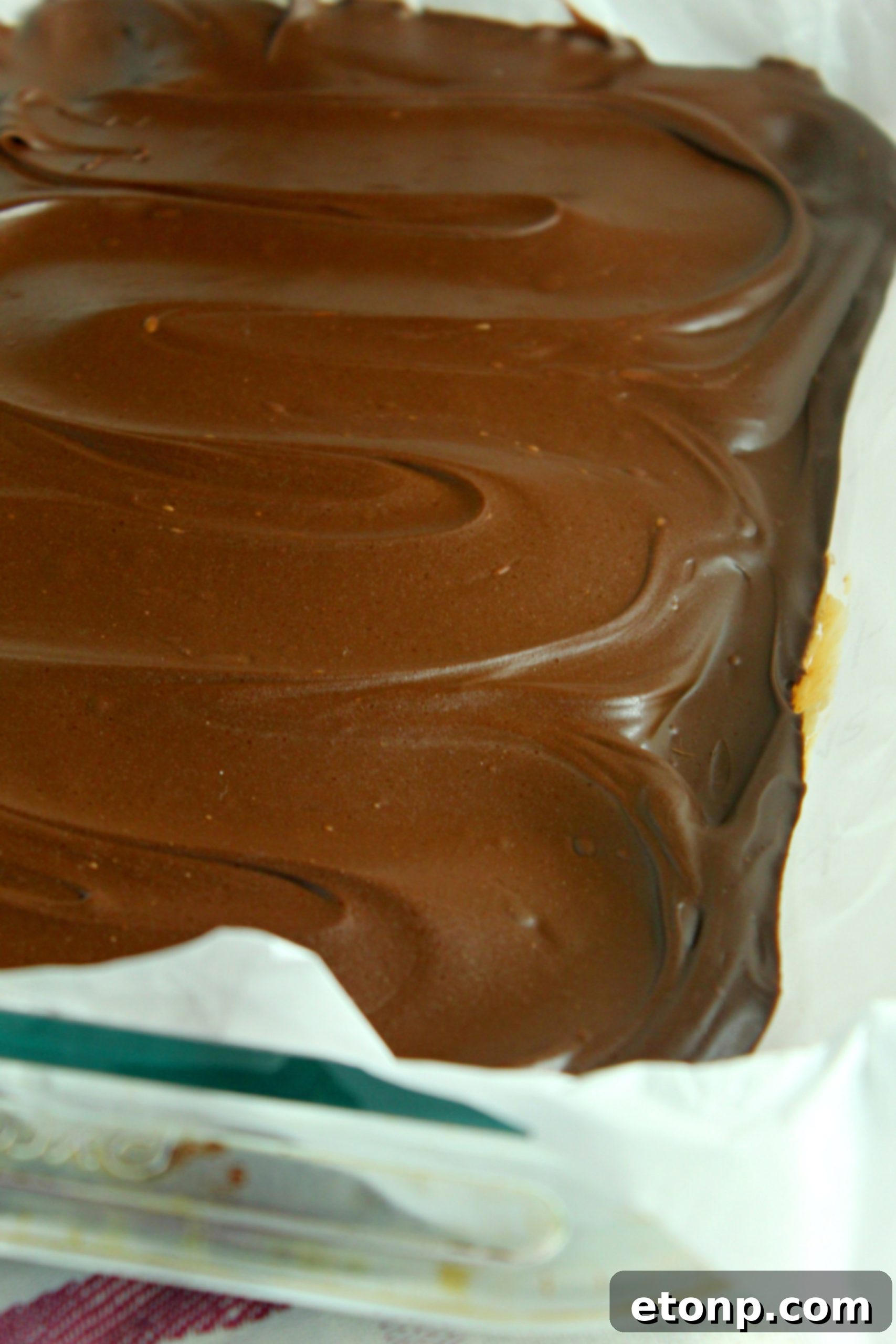 A tray of freshly made No-Bake Peanut Butter Cup Bars, ready to be cut