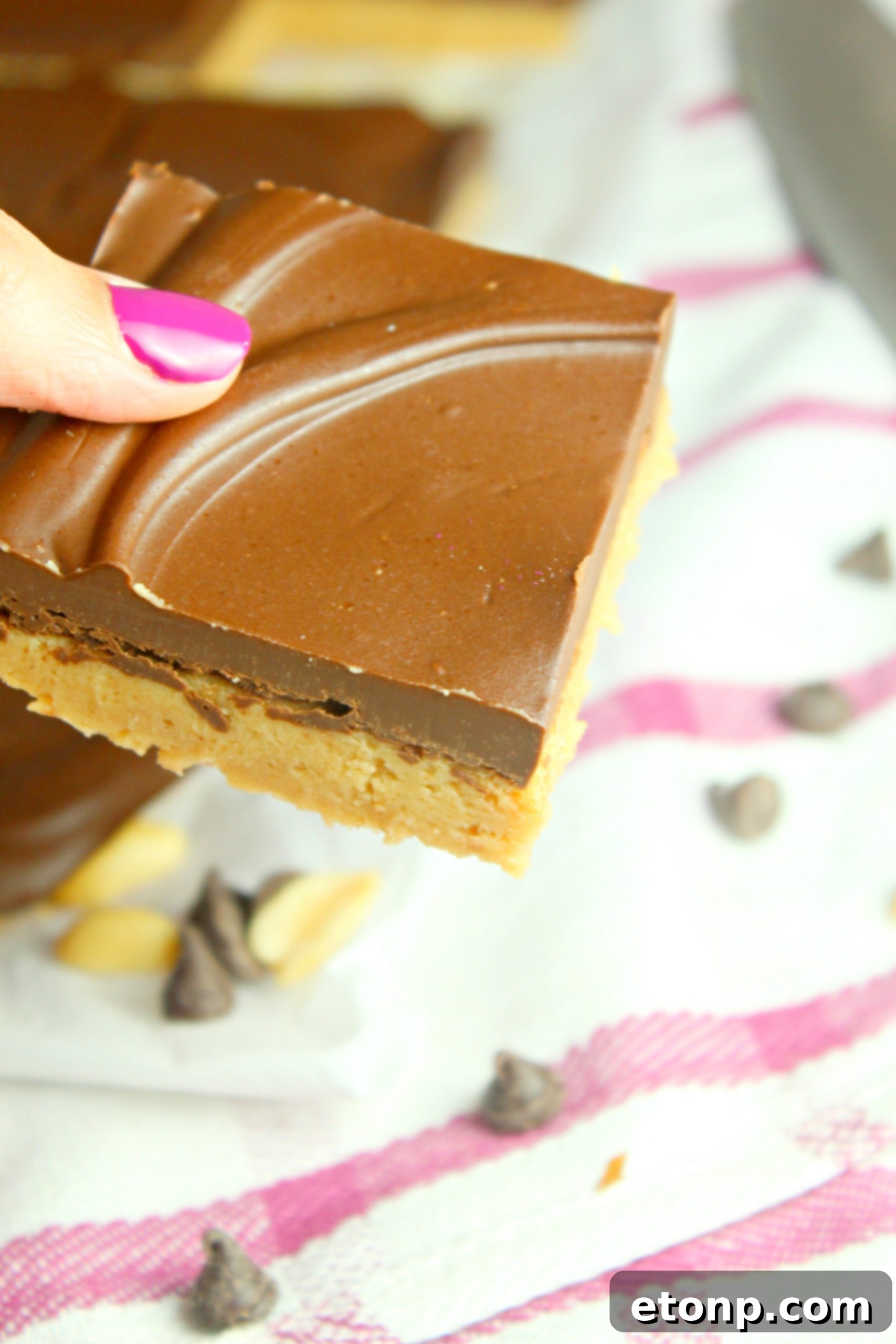 Close-up of a single No-Bake Peanut Butter Cup Bar, showing the thick peanut butter layer
