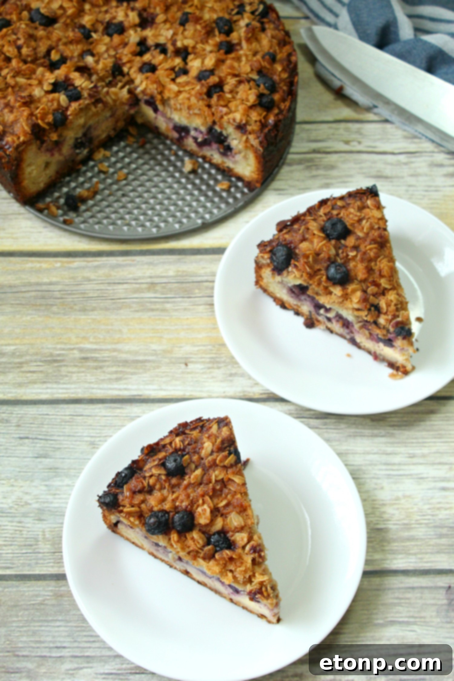 Top view of the blueberry cream cheese coffeecake, showcasing the intricate oat topping and blueberry distribution.