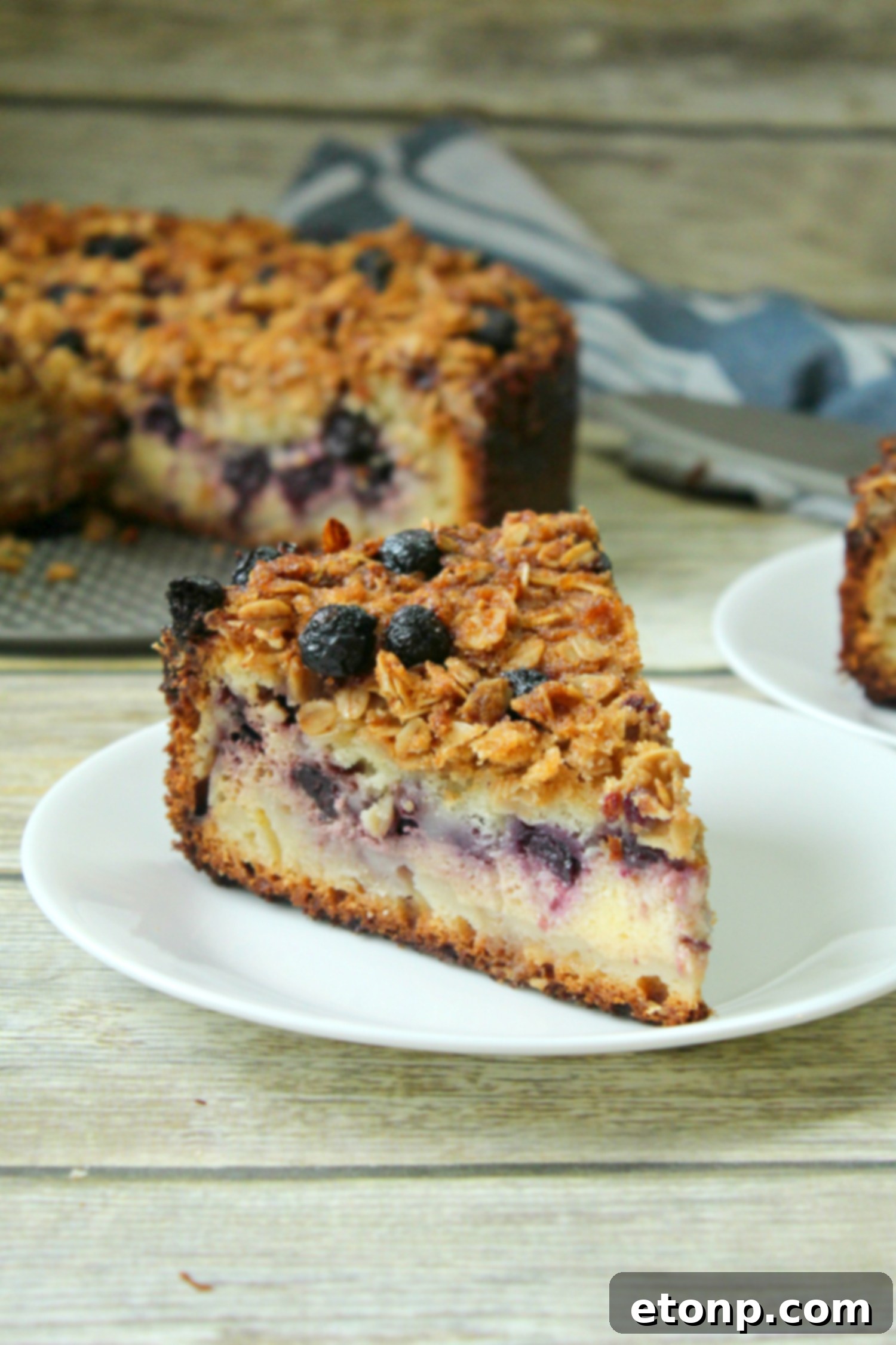 Close-up of a blueberry cream cheese coffeecake slice, focusing on the thick, rich layers.