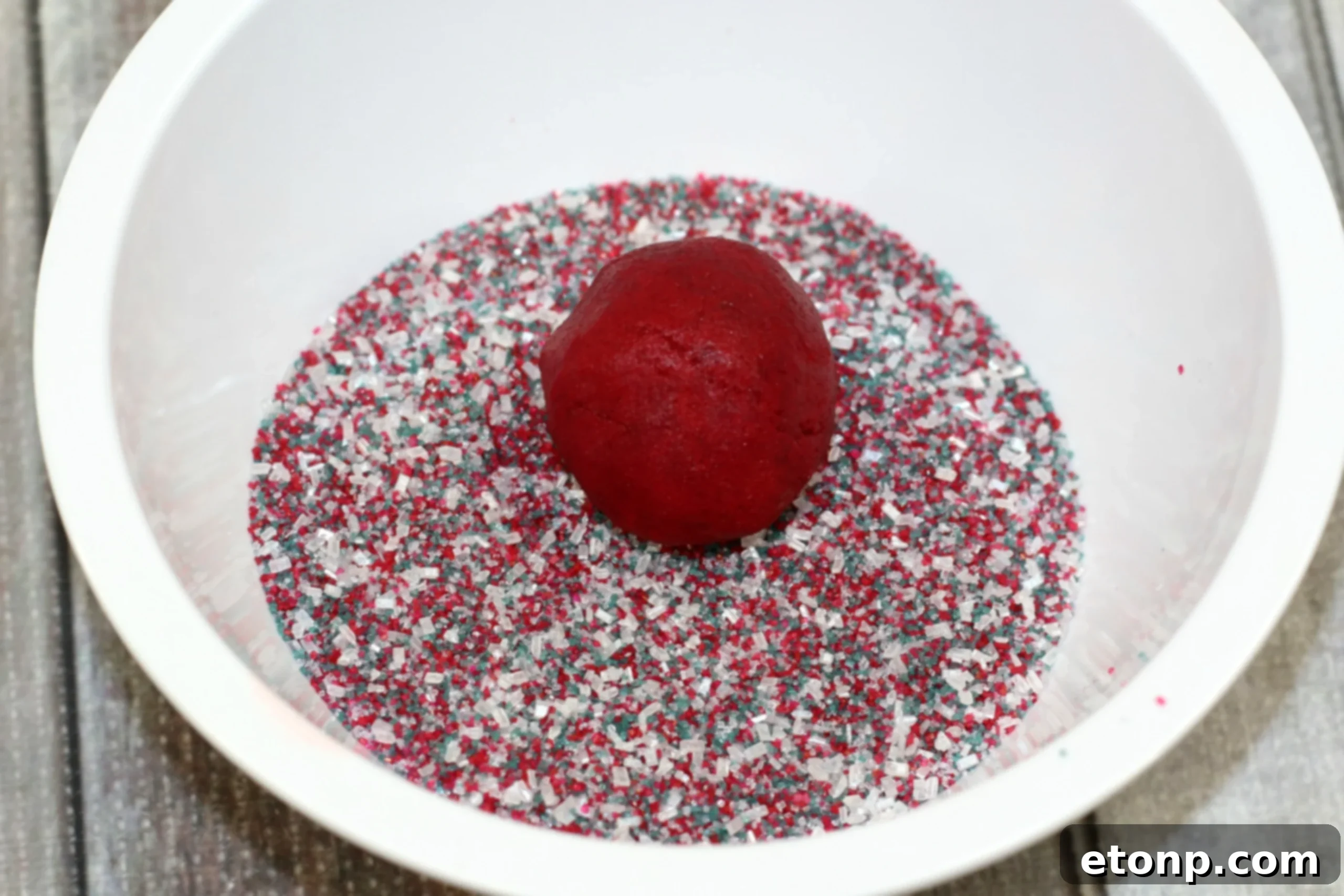 Decadent Red Velvet Cheesecake Thumbprints 3 Overhead shot of Red Velvet Cheesecake Cookies arranged on a cooling rack, showcasing their vibrant red and white centers.