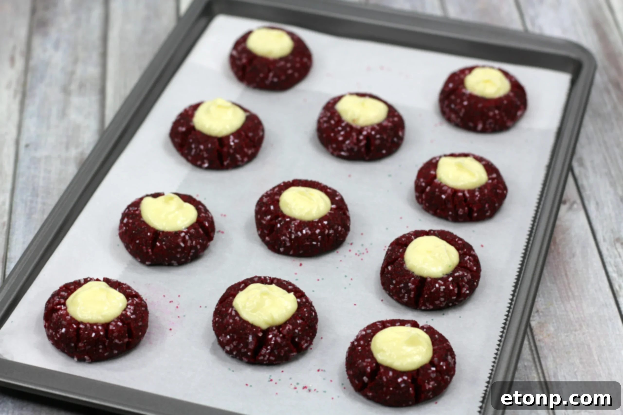 Decadent Red Velvet Cheesecake Thumbprints 5 Artistically arranged Red Velvet Cheesecake Cookies on a white plate, ready for serving.