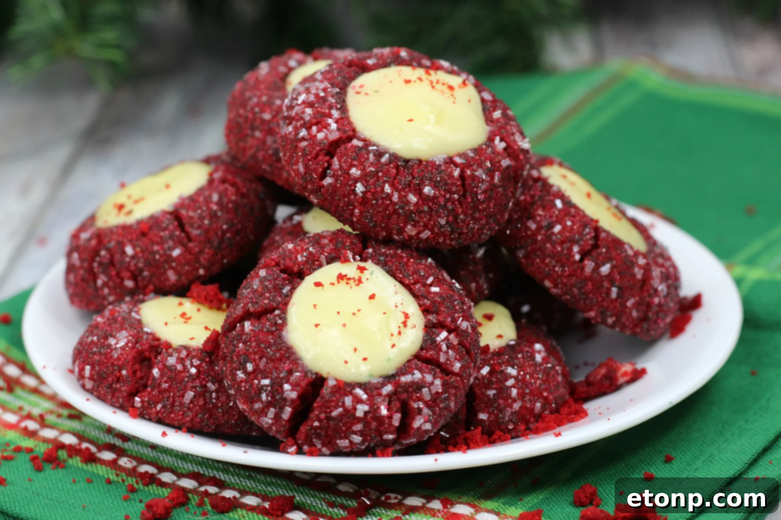 Decadent Red Velvet Cheesecake Thumbprints 6 A close-up of a single Red Velvet Cheesecake Cookie showing its texture and filling.