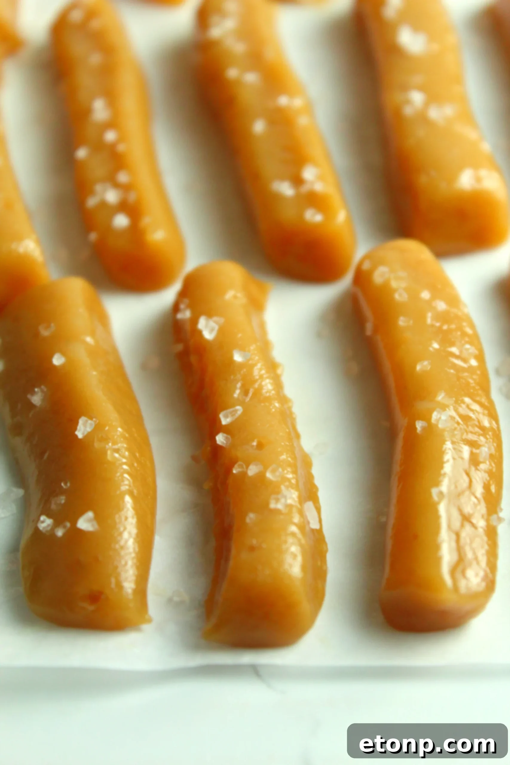 Another enticing close-up of homemade salted caramels arranged beautifully, highlighting their golden brown hue.