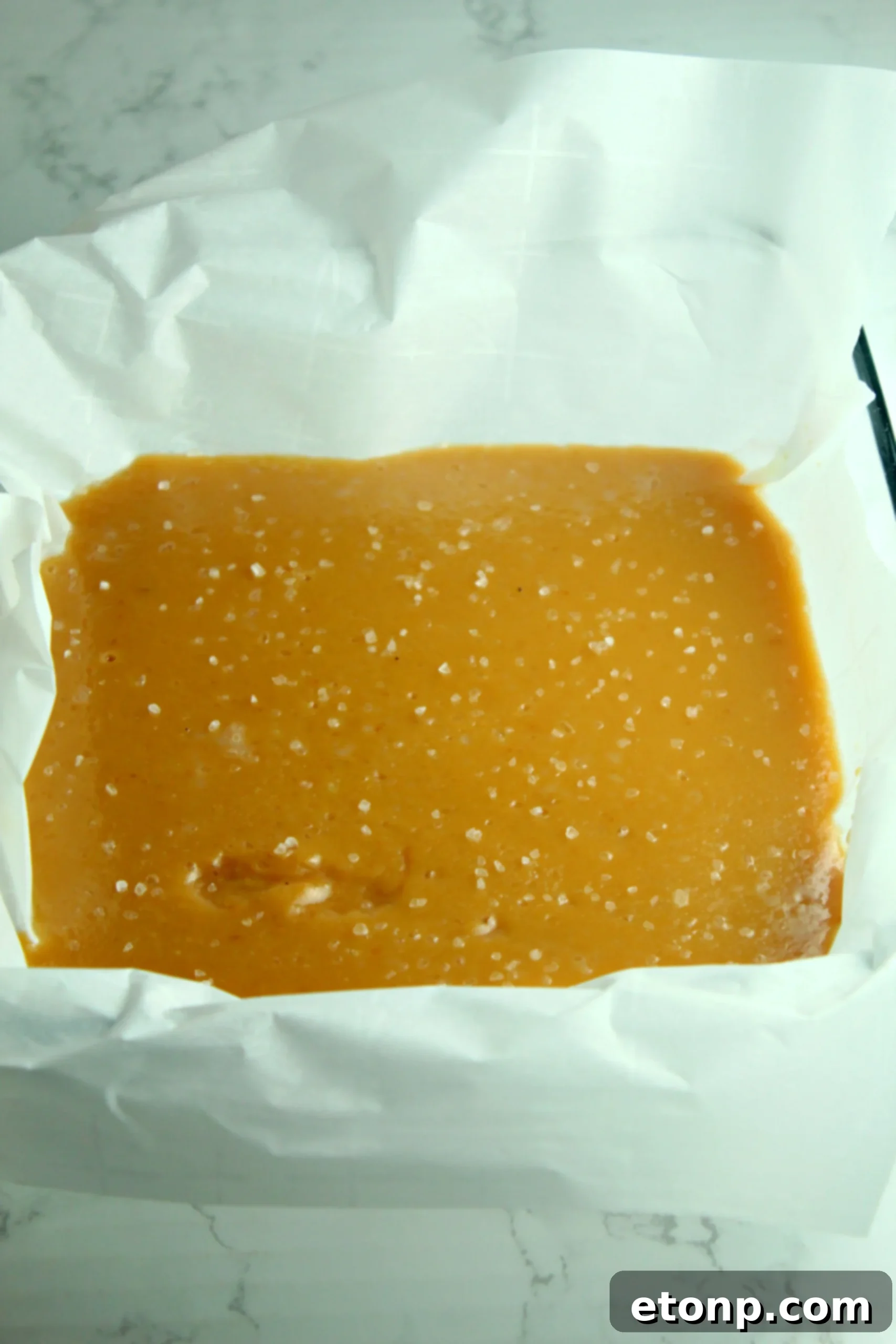 A bounty of homemade salted caramels, unwrapped and ready to be enjoyed or packaged.