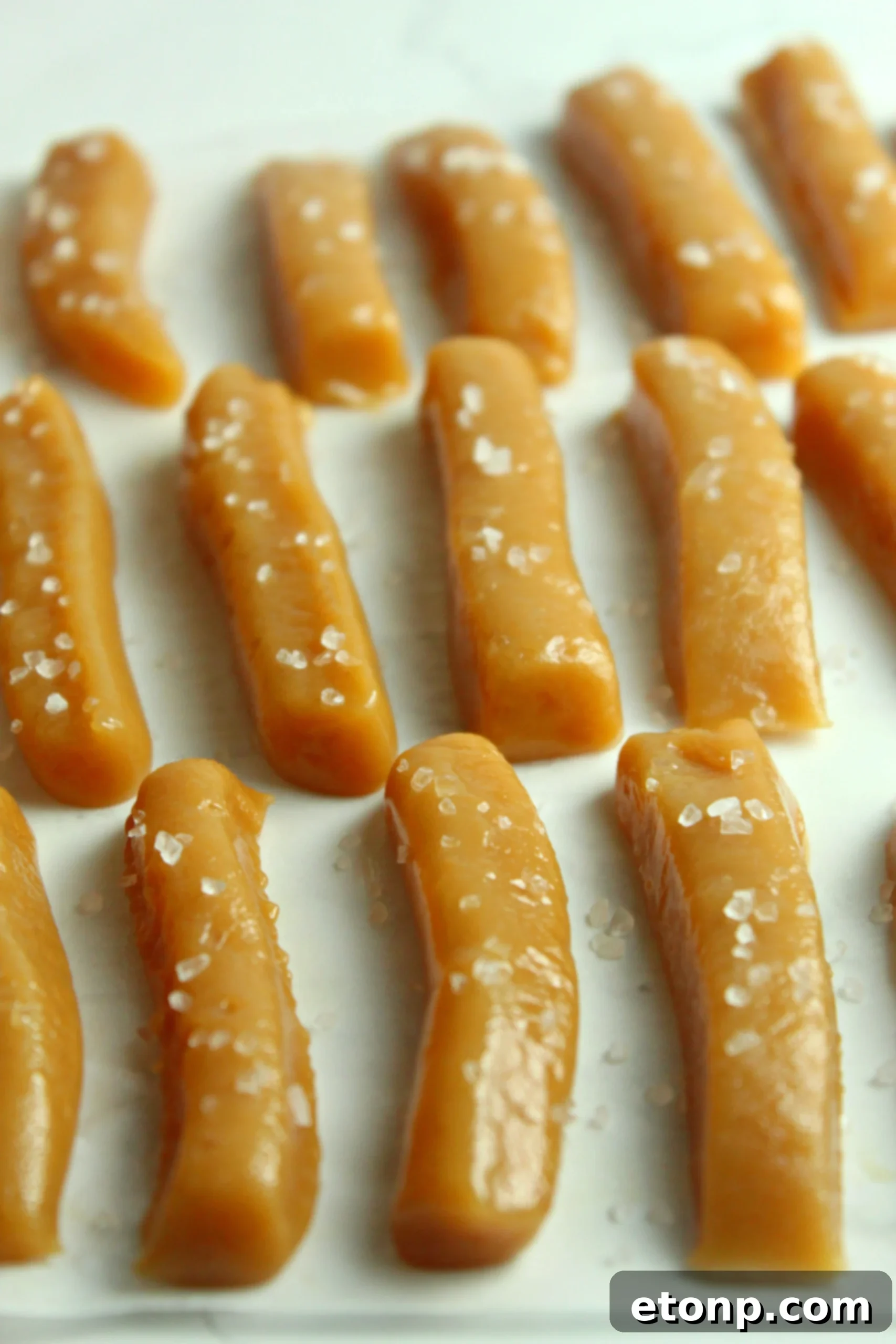 A generous pile of homemade salted caramels, illustrating their abundance and tempting nature.