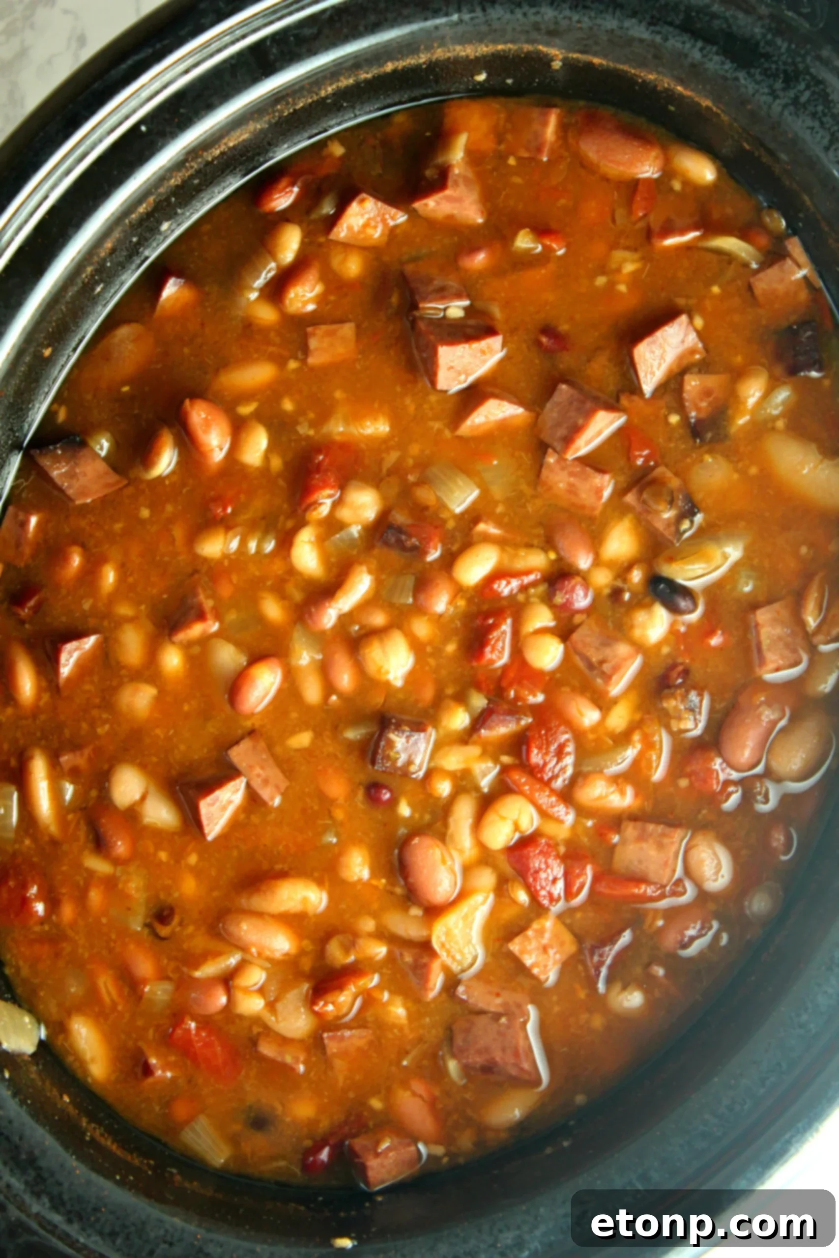 Hearty Ham and Bean Crock-Pot Classic 2 A bowl of Slow Cooker Ham and Bean Soup with crusty bread