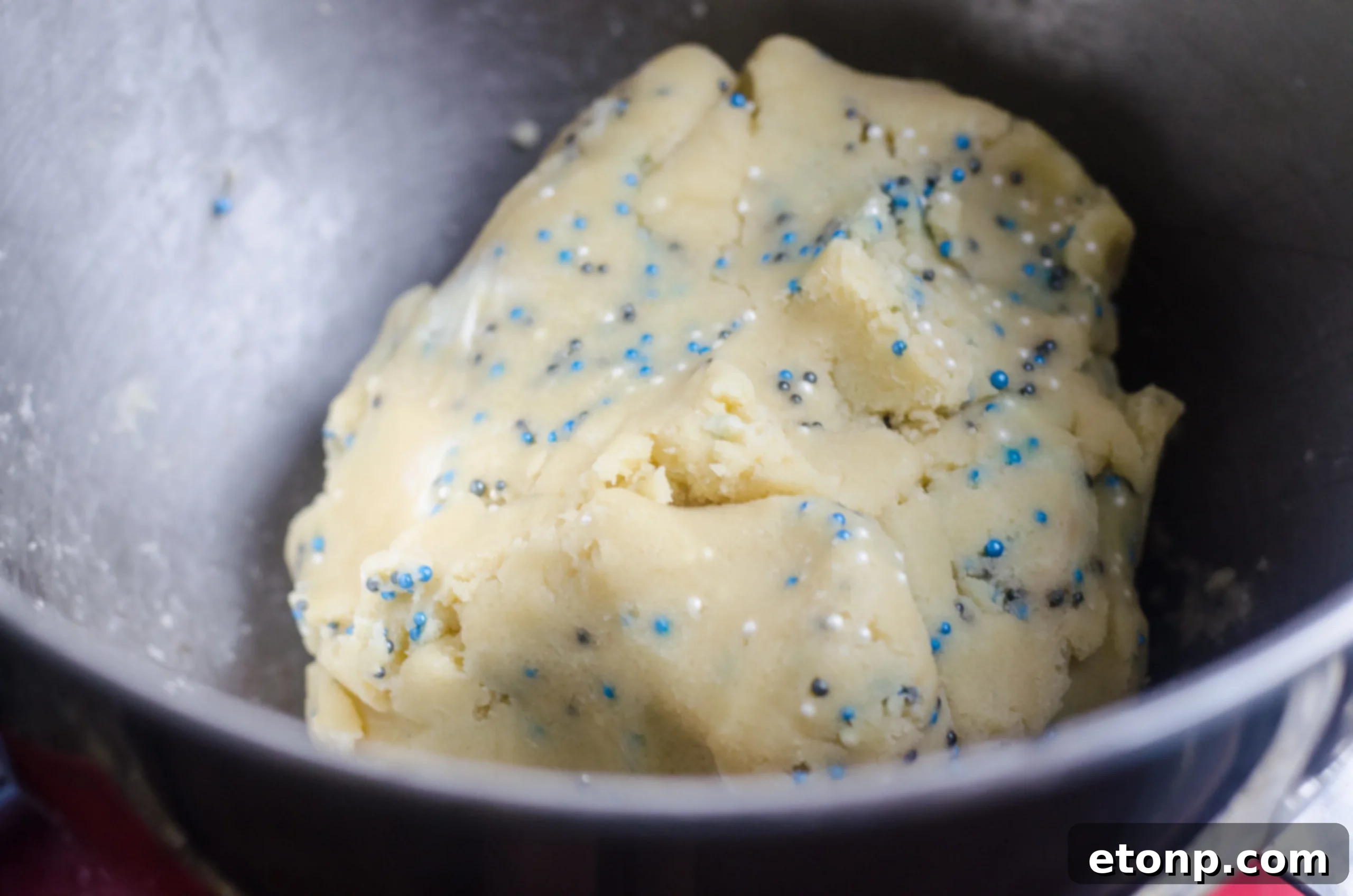Close-up of a plate of freshly baked Winter Shortbread Bites, showcasing their delicious texture and colorful sprinkles.