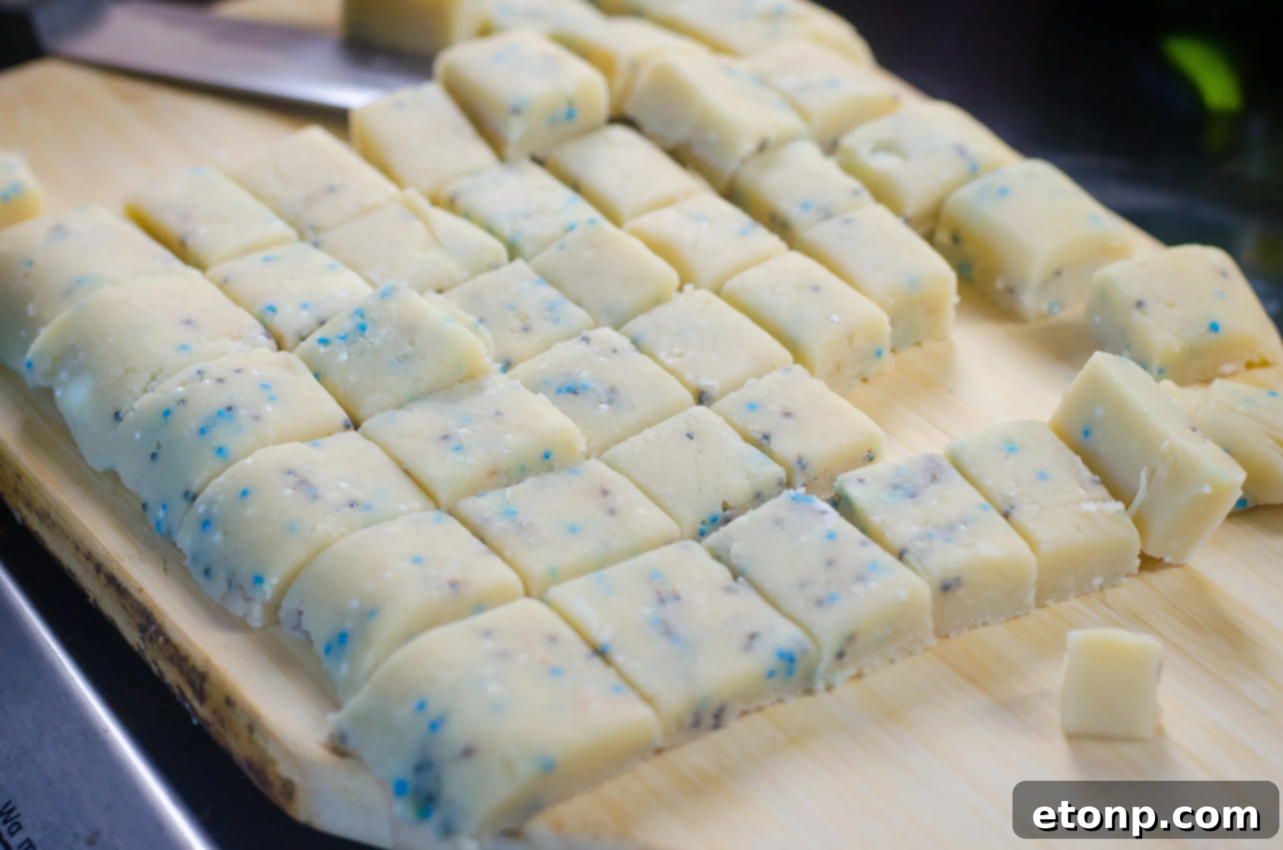 Homemade shortbread bites with sprinkles, artfully arranged on a white plate ready for serving.