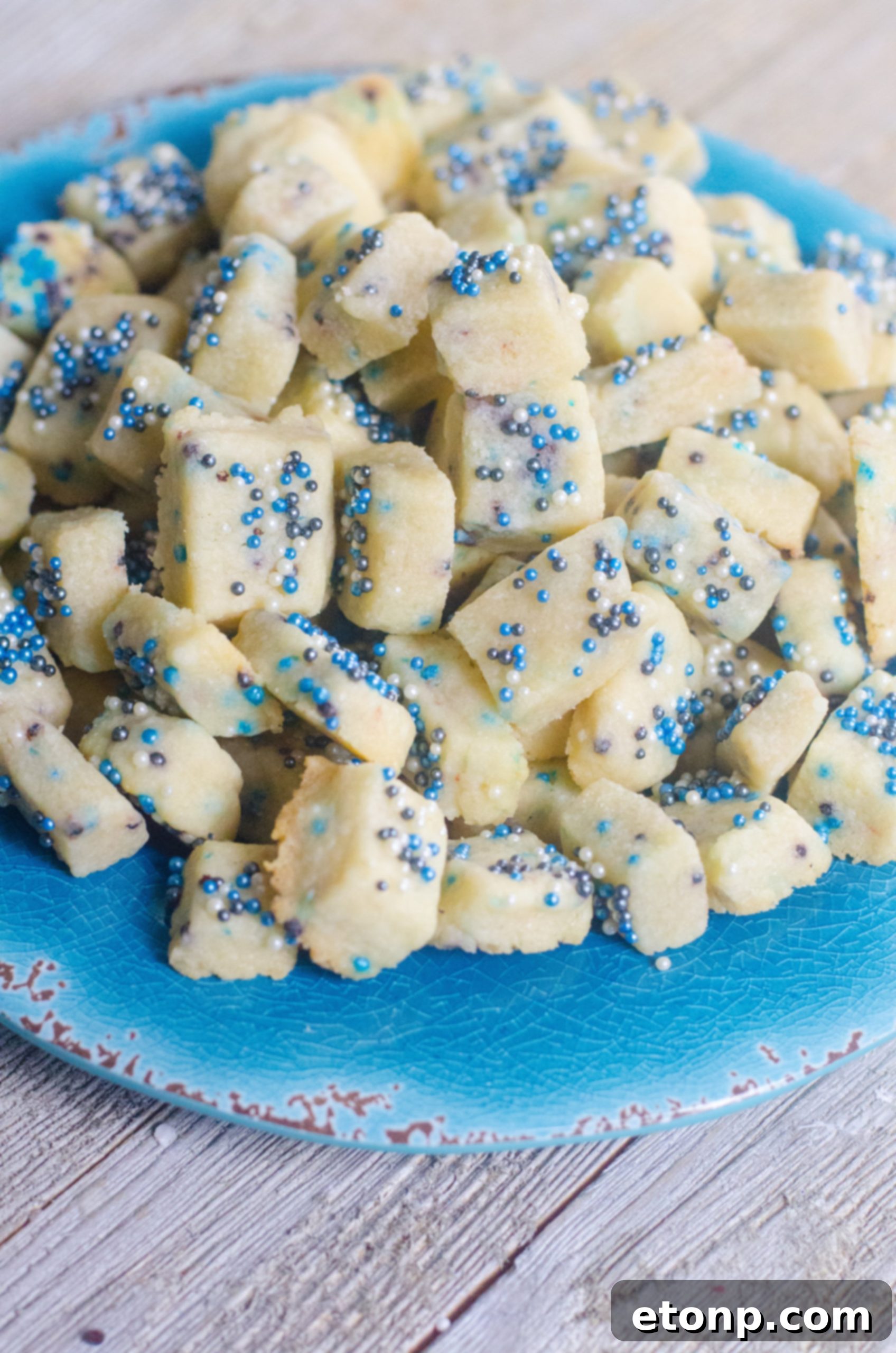 A single Winter Shortbread Bite, perfectly showcasing its buttery texture and colorful sprinkle topping.