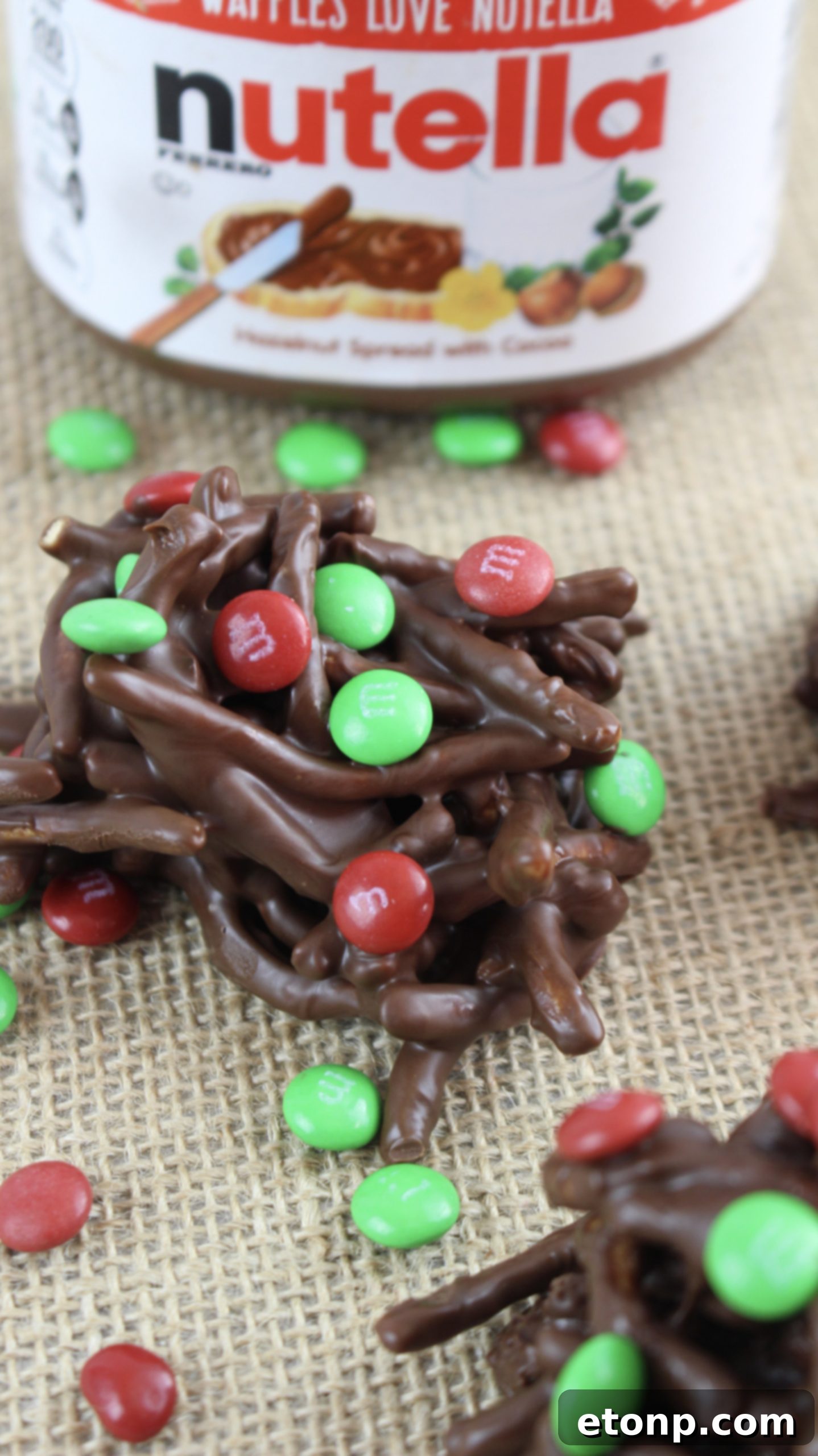 Close-up of a single holiday chocolate haystack with M&M's, showcasing its texture.