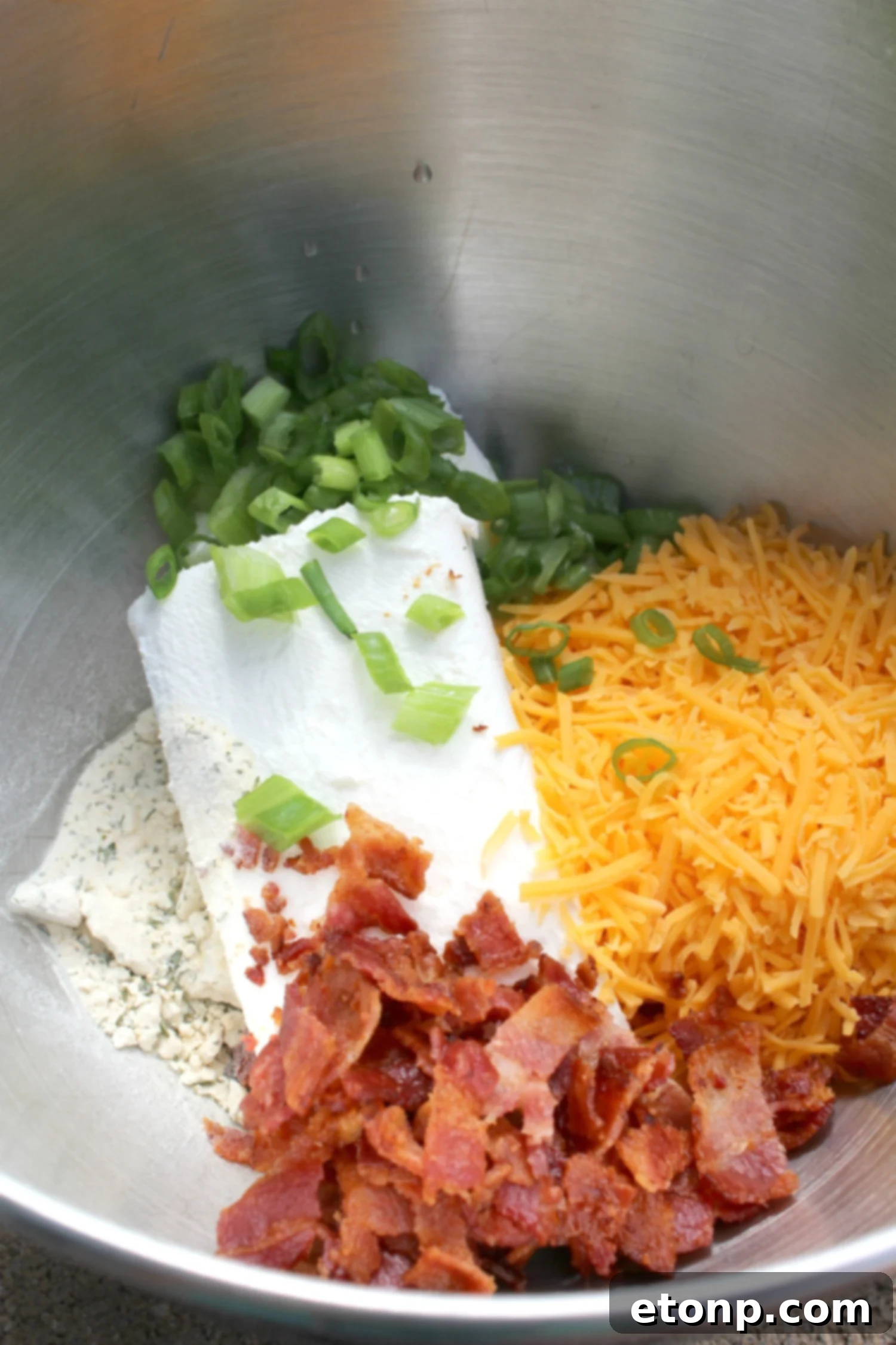 Bacon Cheddar Ranch Cheeseball ready to be served with a variety of crackers and vegetables