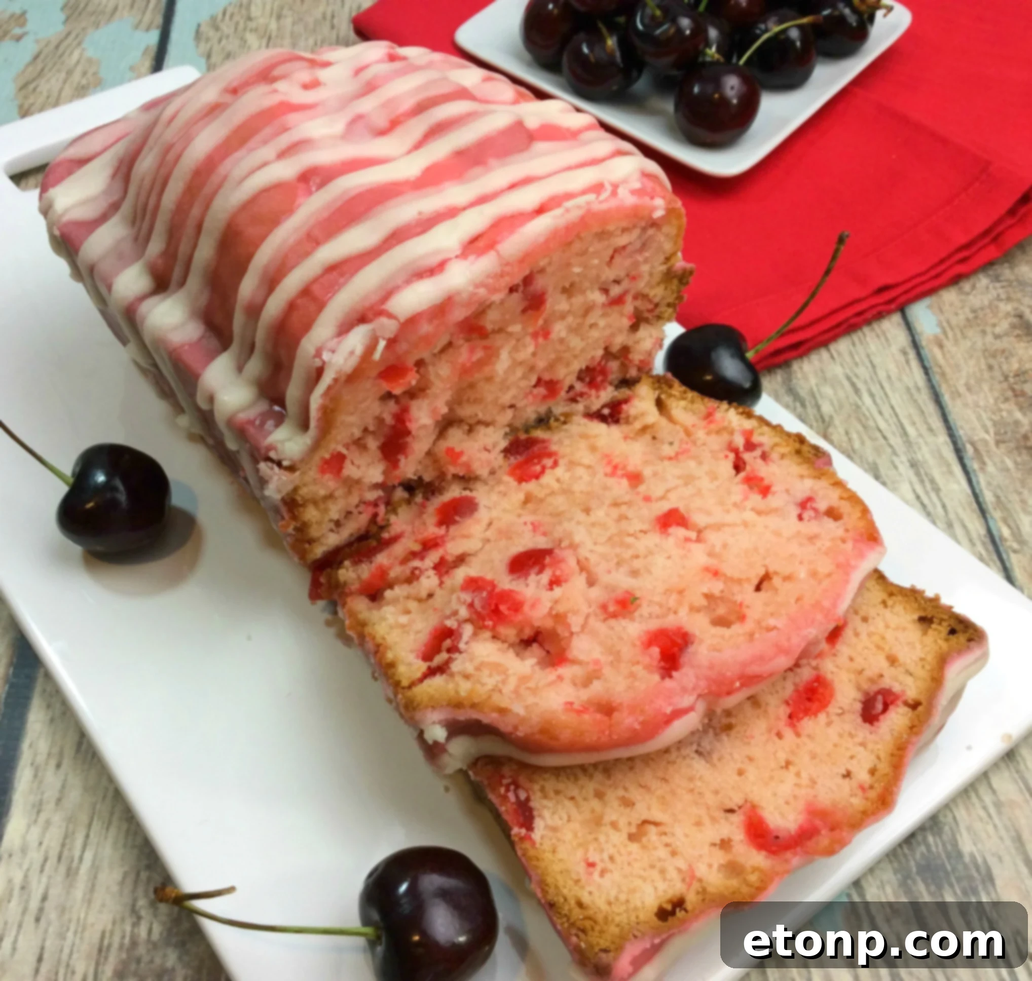 Close-up of the Cherry Garcia Loaf Cake, highlighting its soft crumb and generous distribution of bright red cherries.