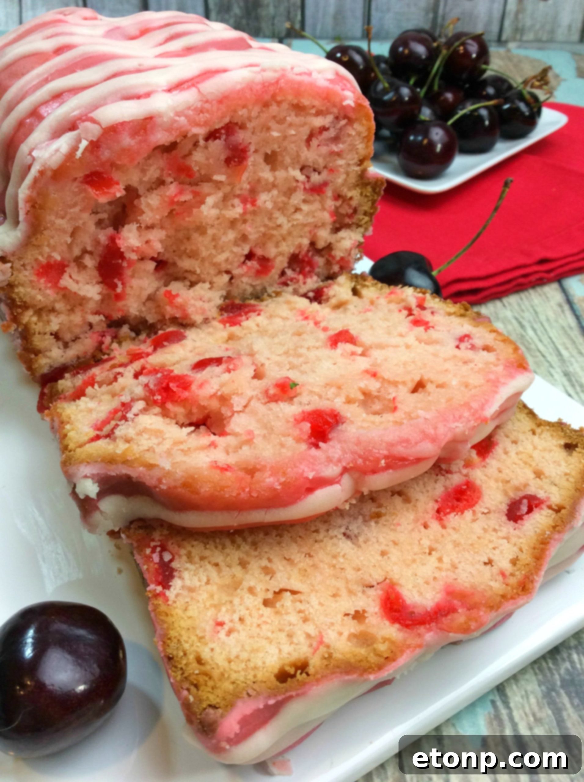 The full Cherry Garcia Loaf Cake, beautifully glazed and presented, ready for slicing.