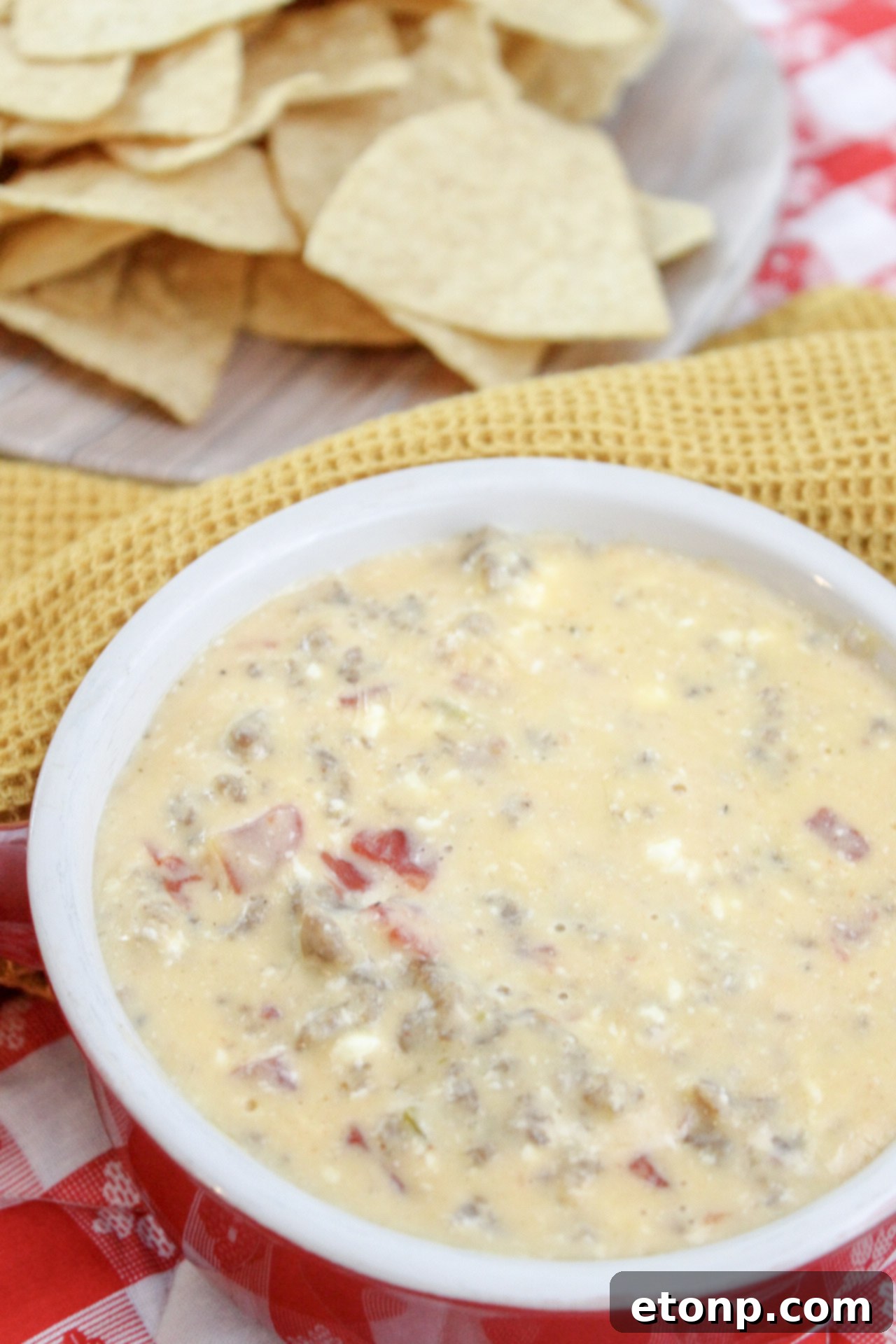 The finished article page for the cheesy sausage dip recipe, showing the inviting dish and encouraging users to share and engage.