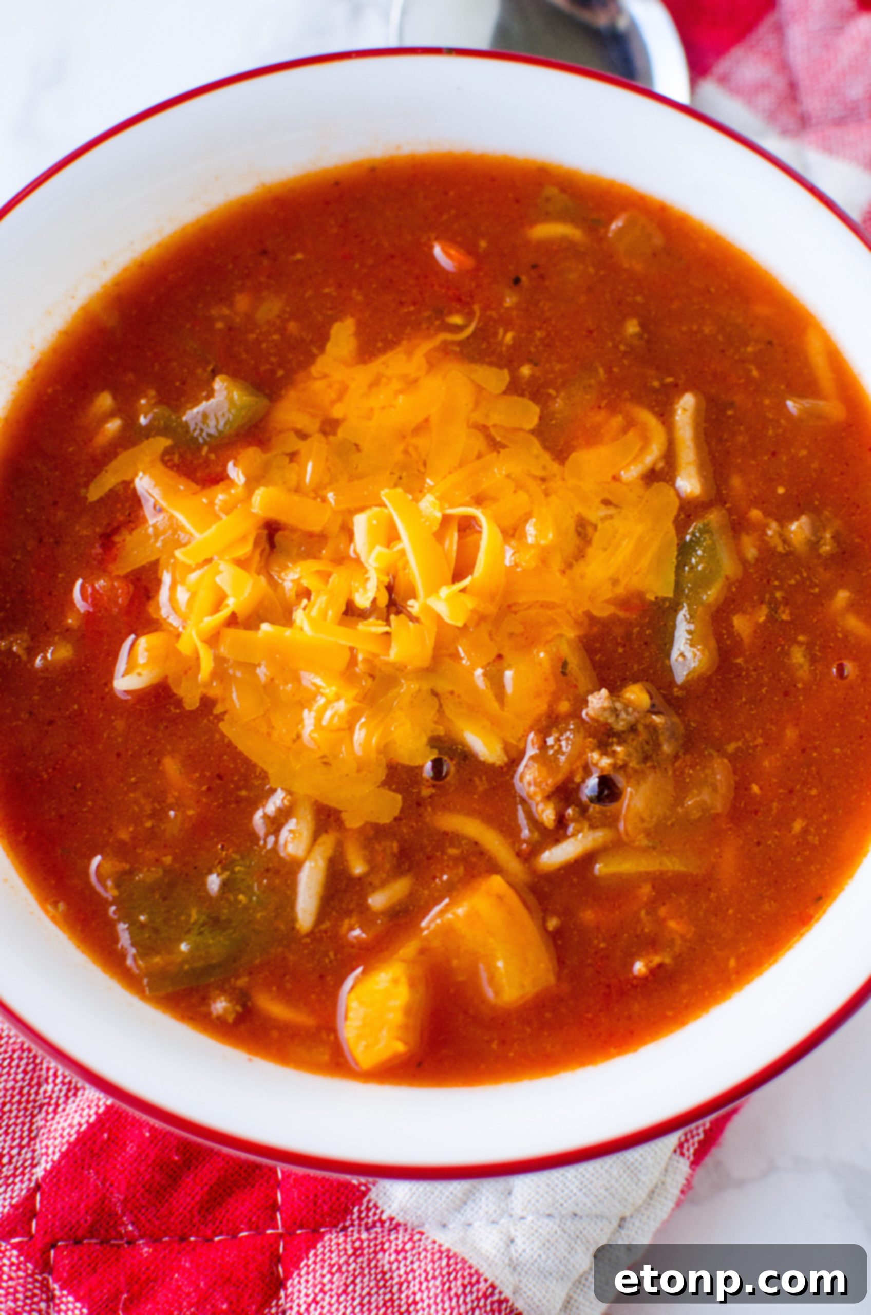 Stuffed Pepper Soup served in a rustic bowl with a spoon, ready to be eaten.