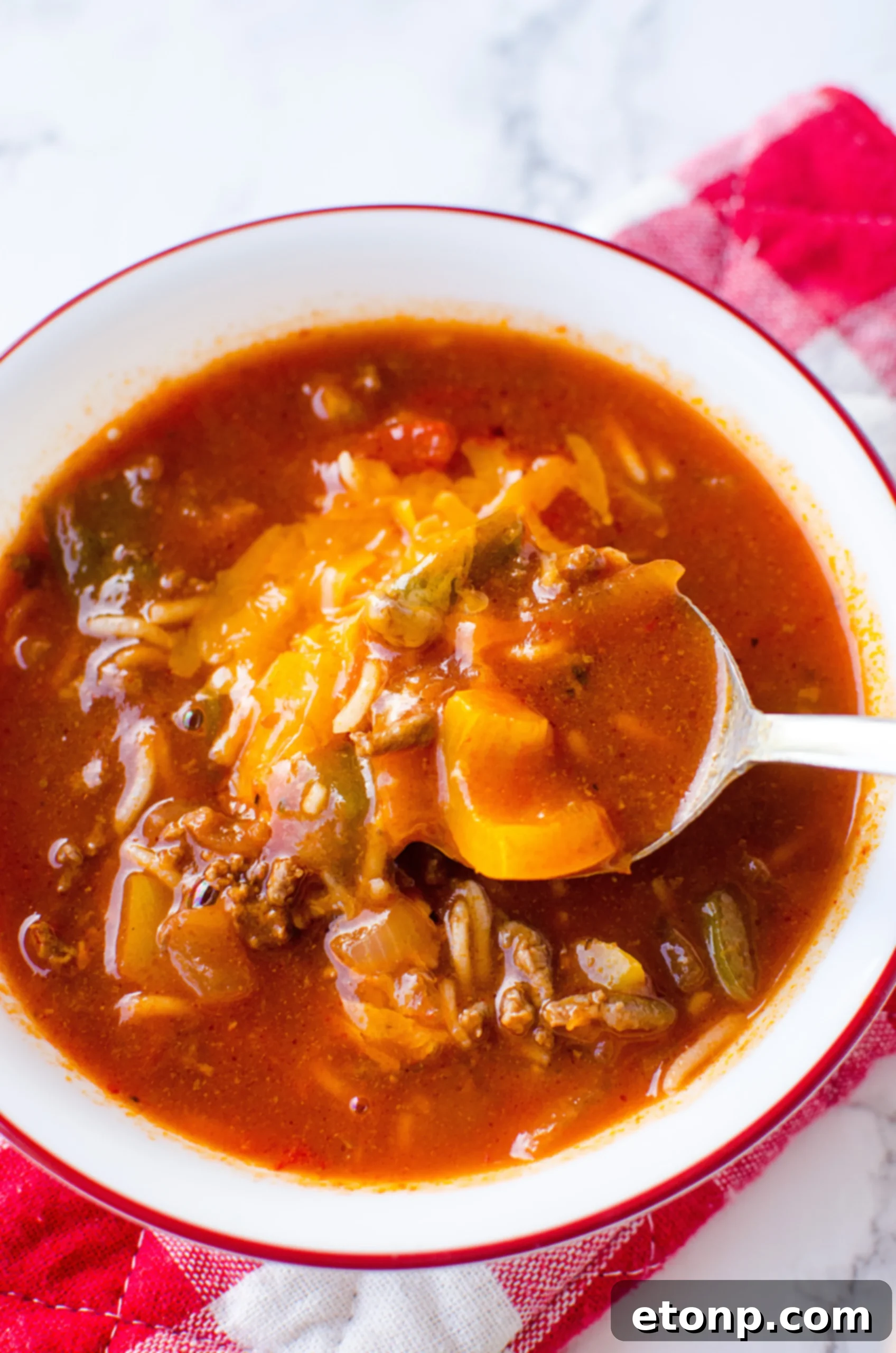 An overhead shot of Stuffed Pepper Soup, highlighting the vibrant colors of bell peppers and the hearty texture of the beef and rice.