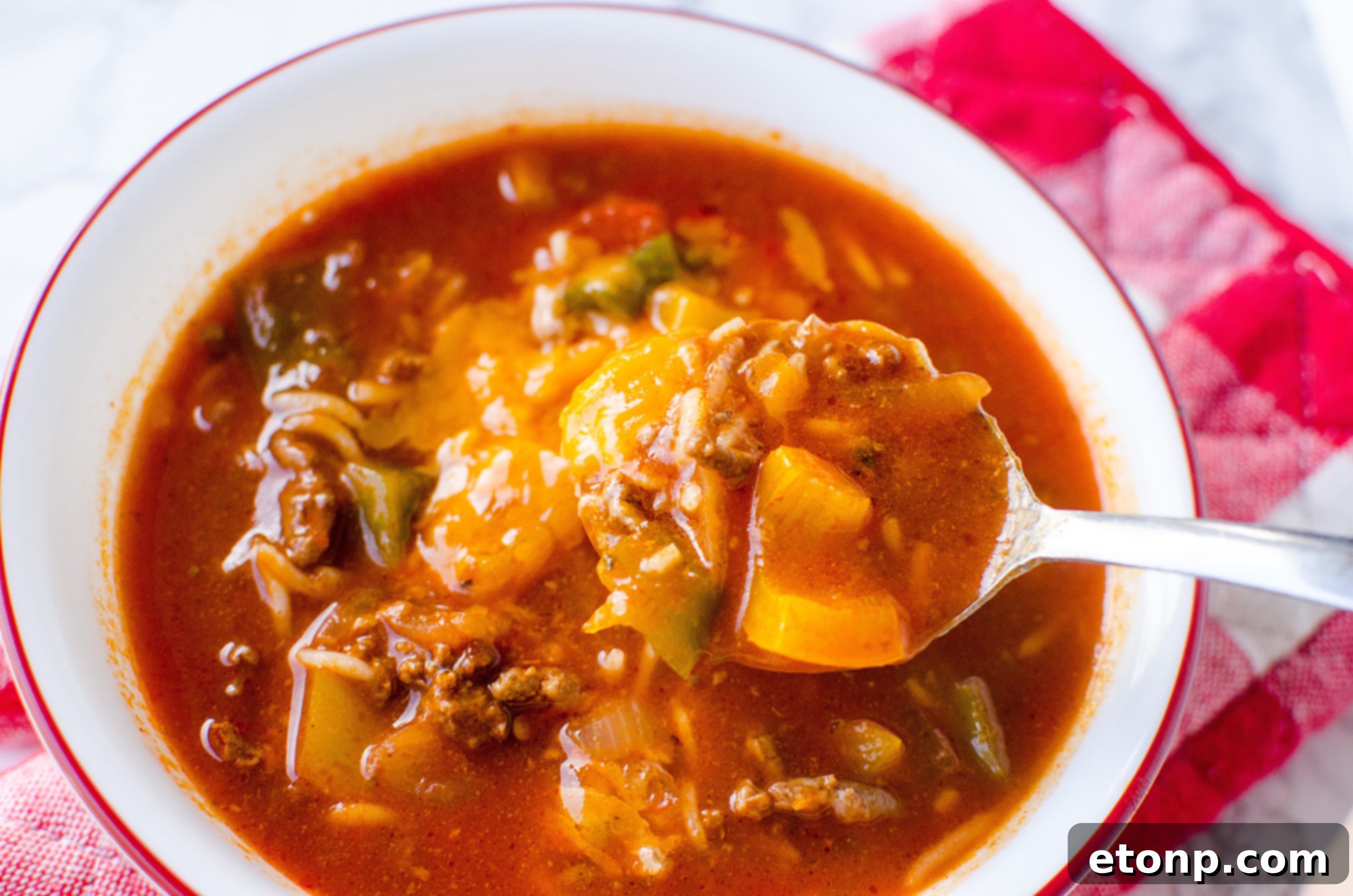 Multiple bowls of Stuffed Pepper Soup arranged on a wooden table, emphasizing its abundance and inviting presentation.