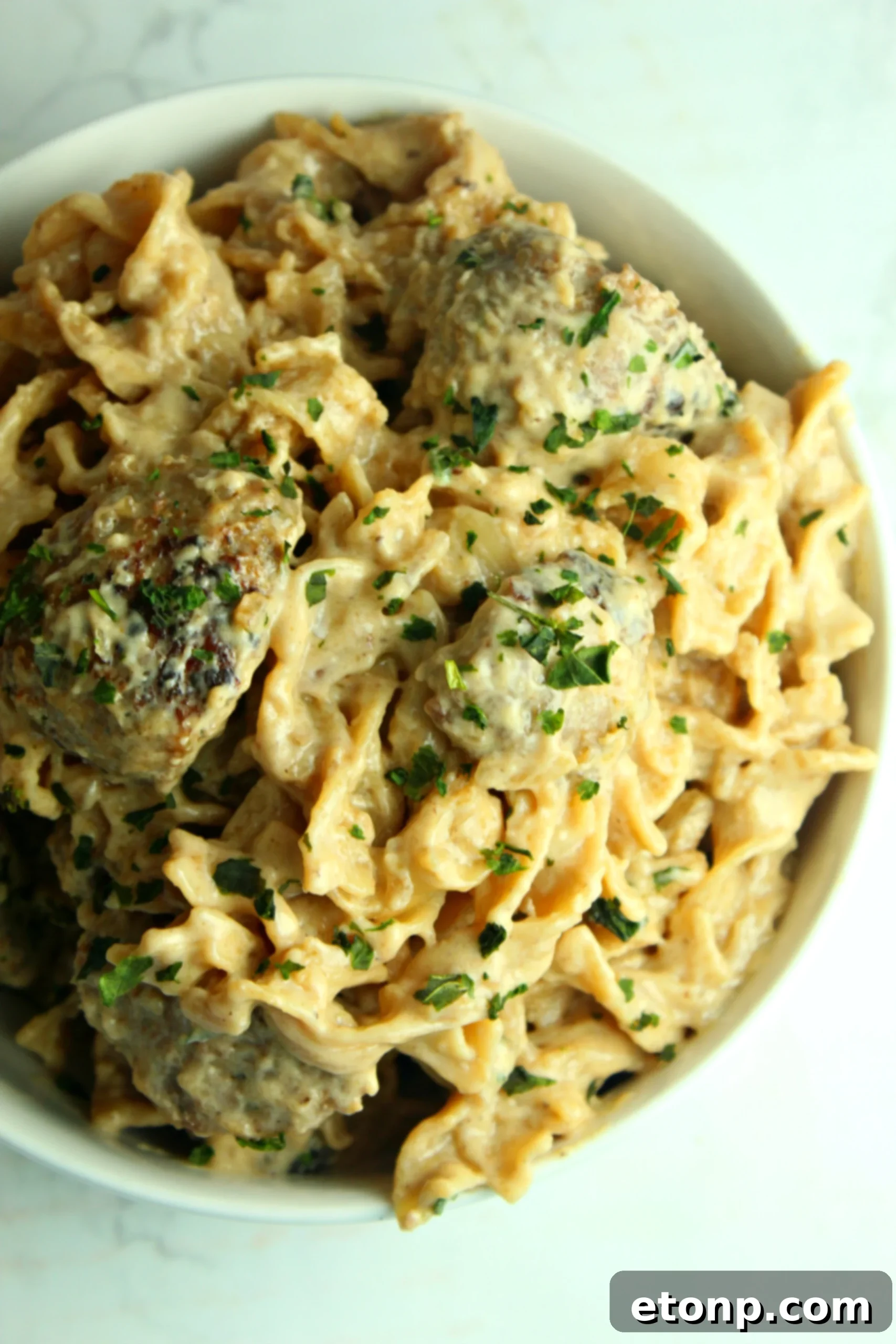 Creamy French Onion Sausage Pasta in a serving dish, ready for the family