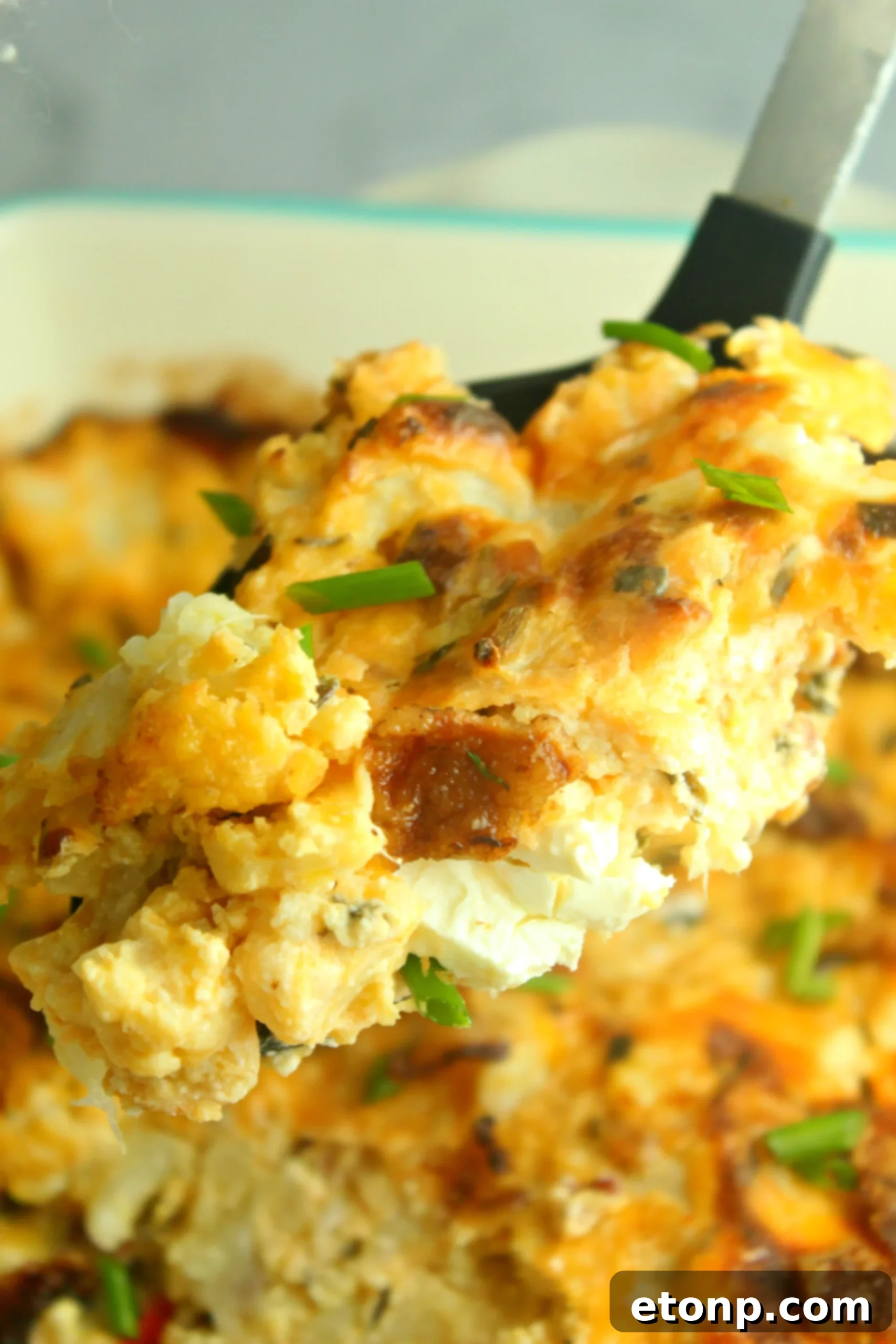 Loaded Cheesy Cauliflower Casserole, a delicious low-carb and keto-friendly dish with melted cheese and fresh chives.