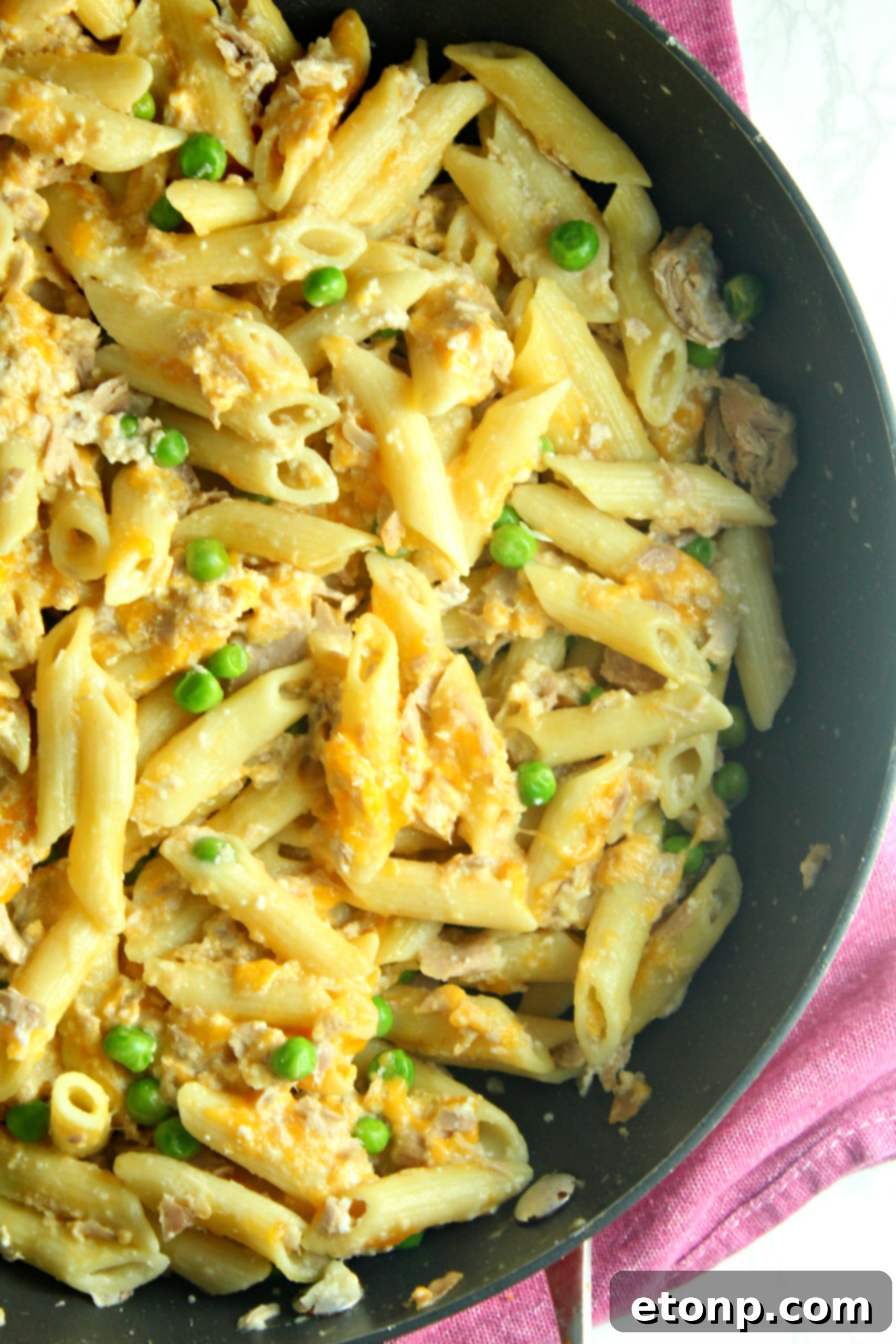 Cheesy Tuna Casserole garnished with fresh parsley and a topping suggestion
