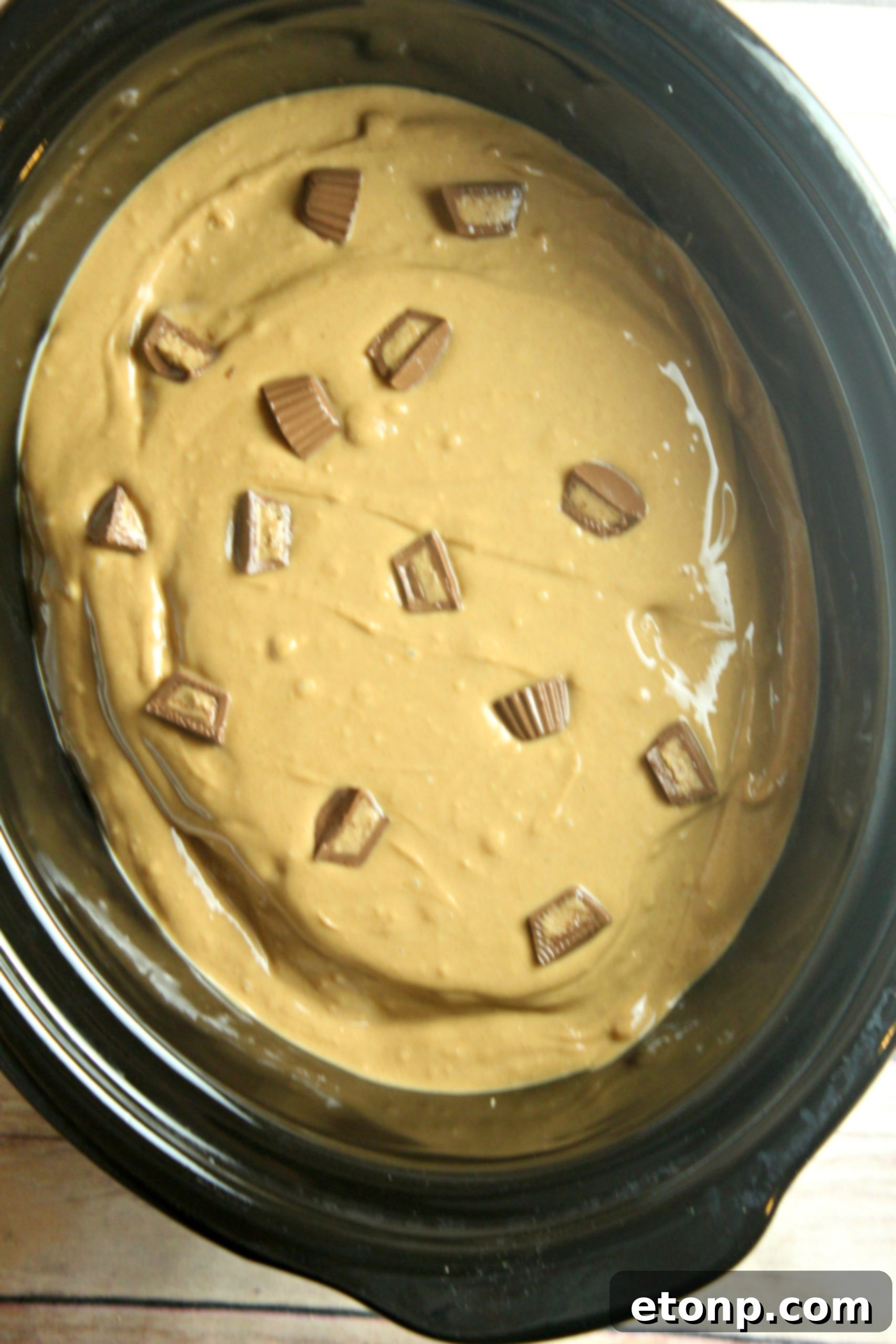 Close-up of the delicious Slow Cooker Reese's Peanut Butter Chocolate Cake with peanut butter cups folded into the batter