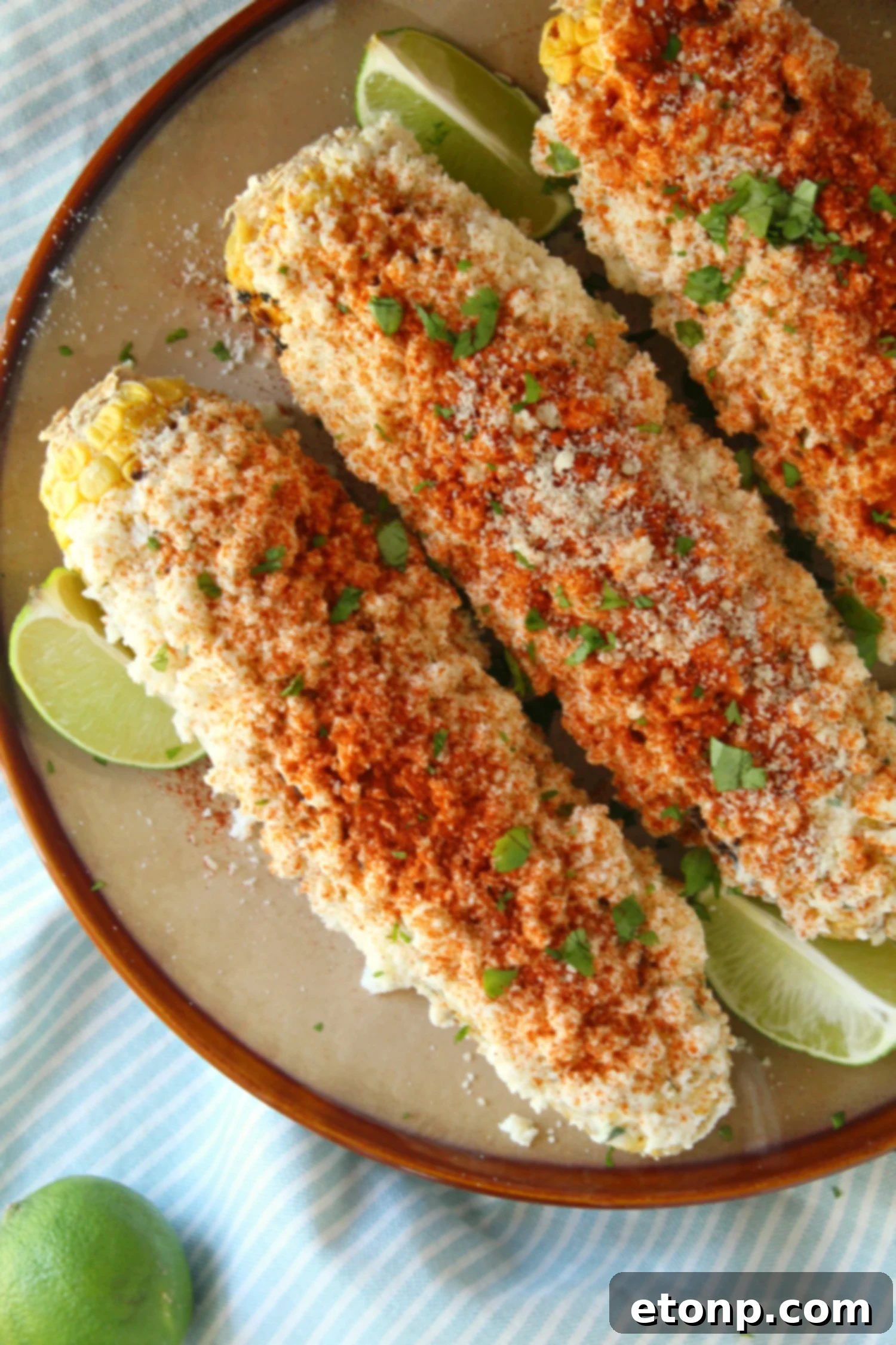 Plated Mexican Street Corn with lime and cilantro garnish