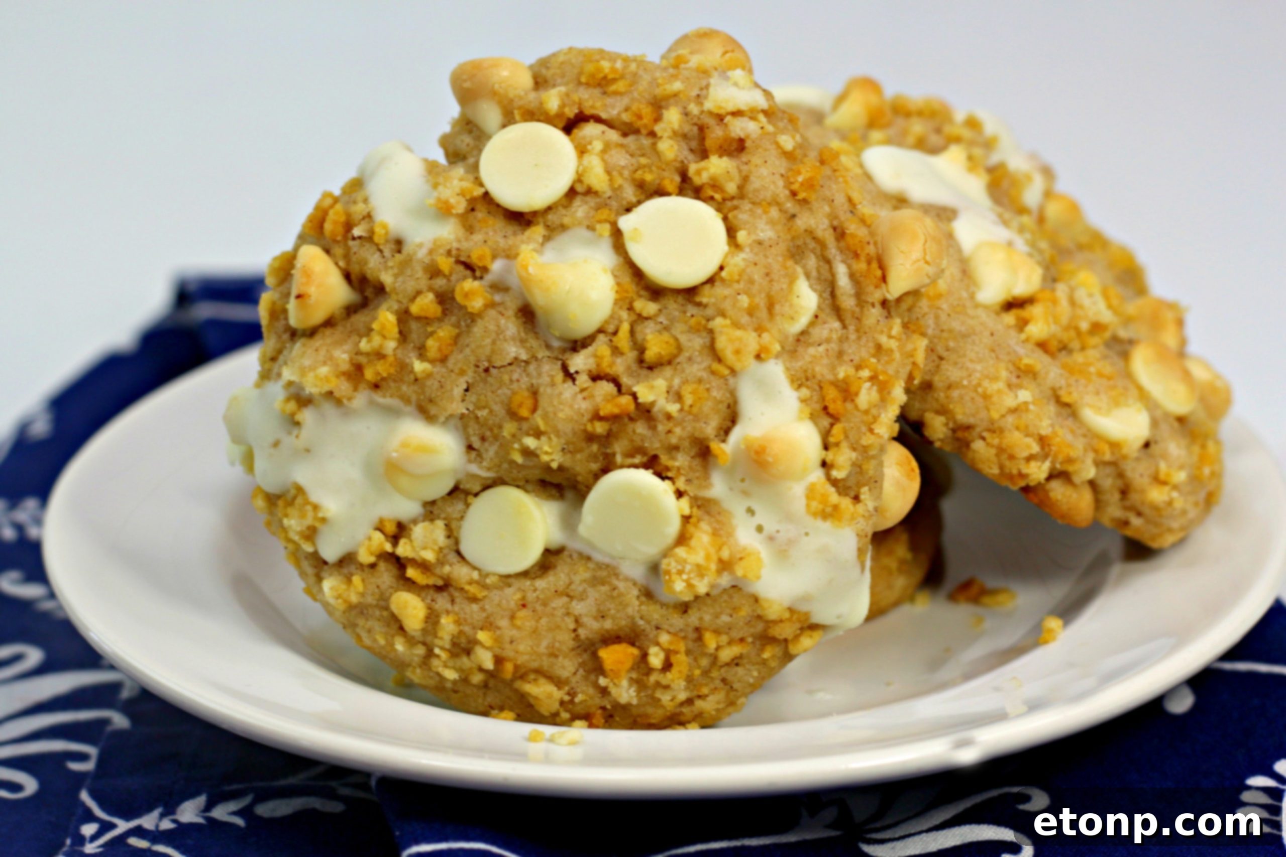 Cinnamon Roll Stuffed Cookies generously drizzled with creamy white frosting