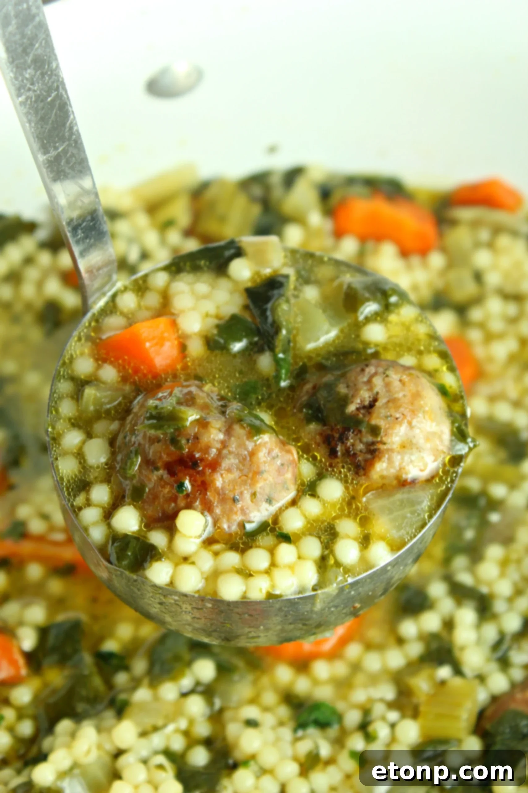 Delicious Italian Wedding Soup served with a side of warm, crusty bread, perfect for dipping.