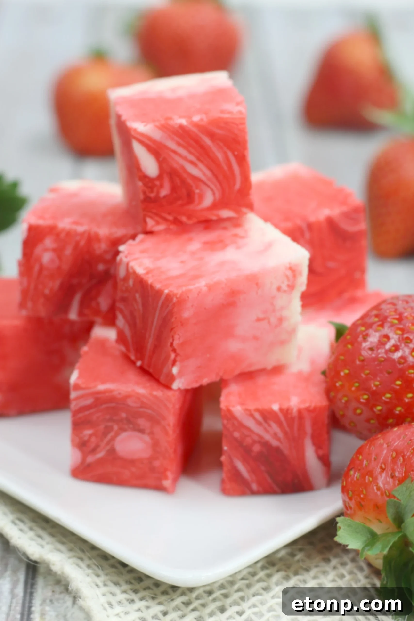 Neatly cut squares of strawberry swirl fudge presented in a gift-ready manner