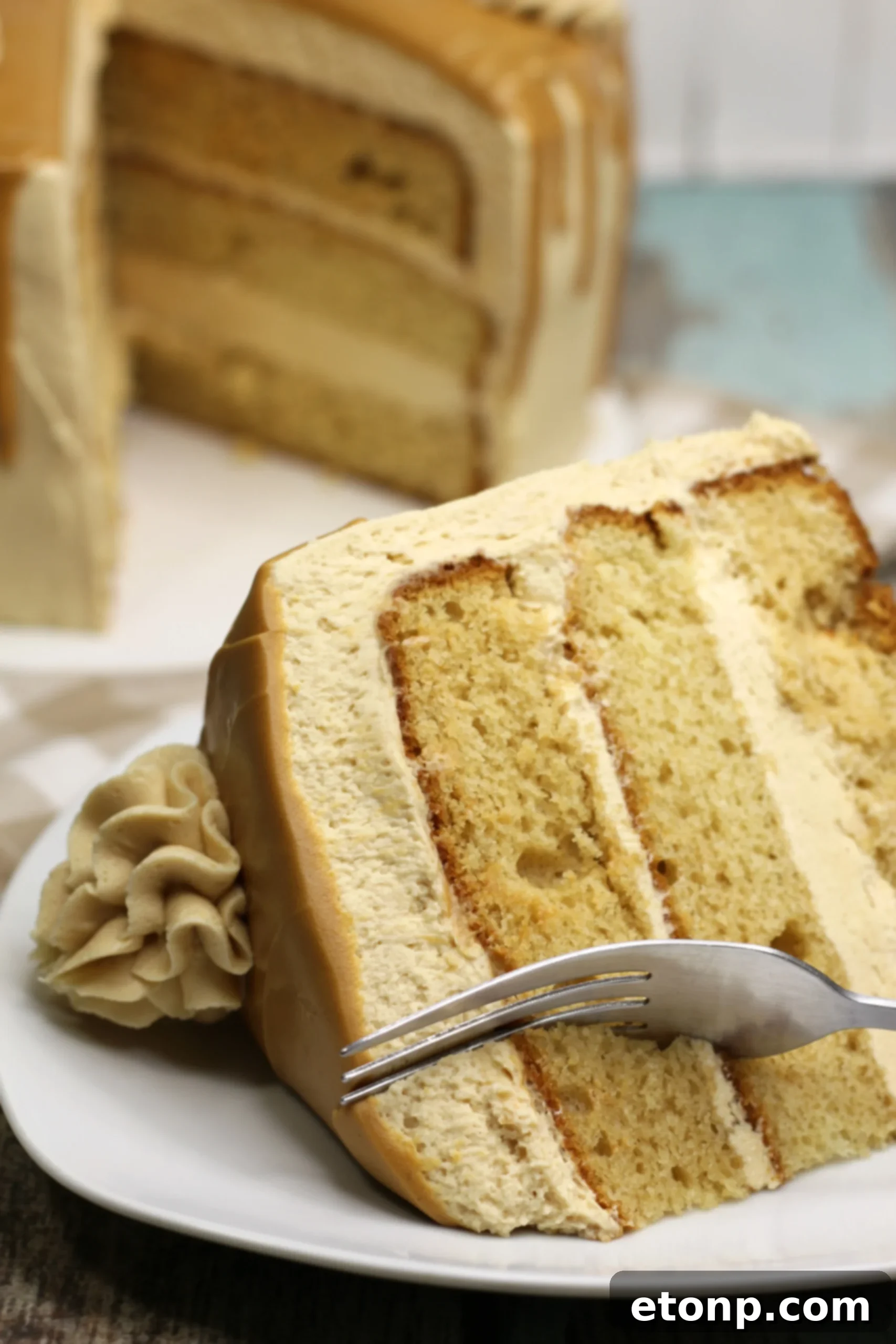 Sinfully Good Peanut Butter Cake 2 A stunning three-layer peanut butter cake, generously frosted and drizzled with a smooth peanut butter glaze, ready to be served.