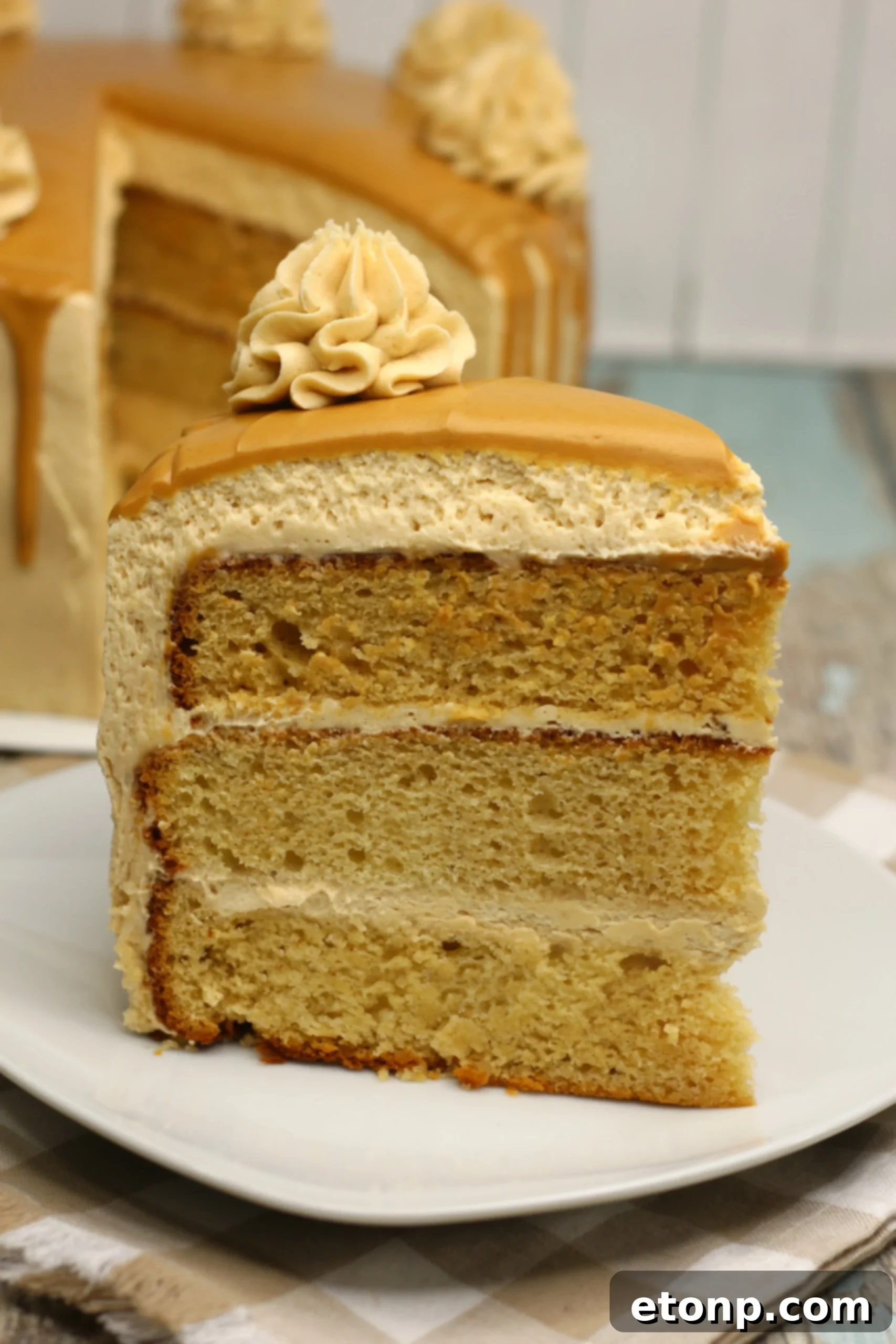 Sinfully Good Peanut Butter Cake 4 A beautifully decorated peanut butter layered cake, showcasing the smooth frosting and elegant peanut butter drizzle.