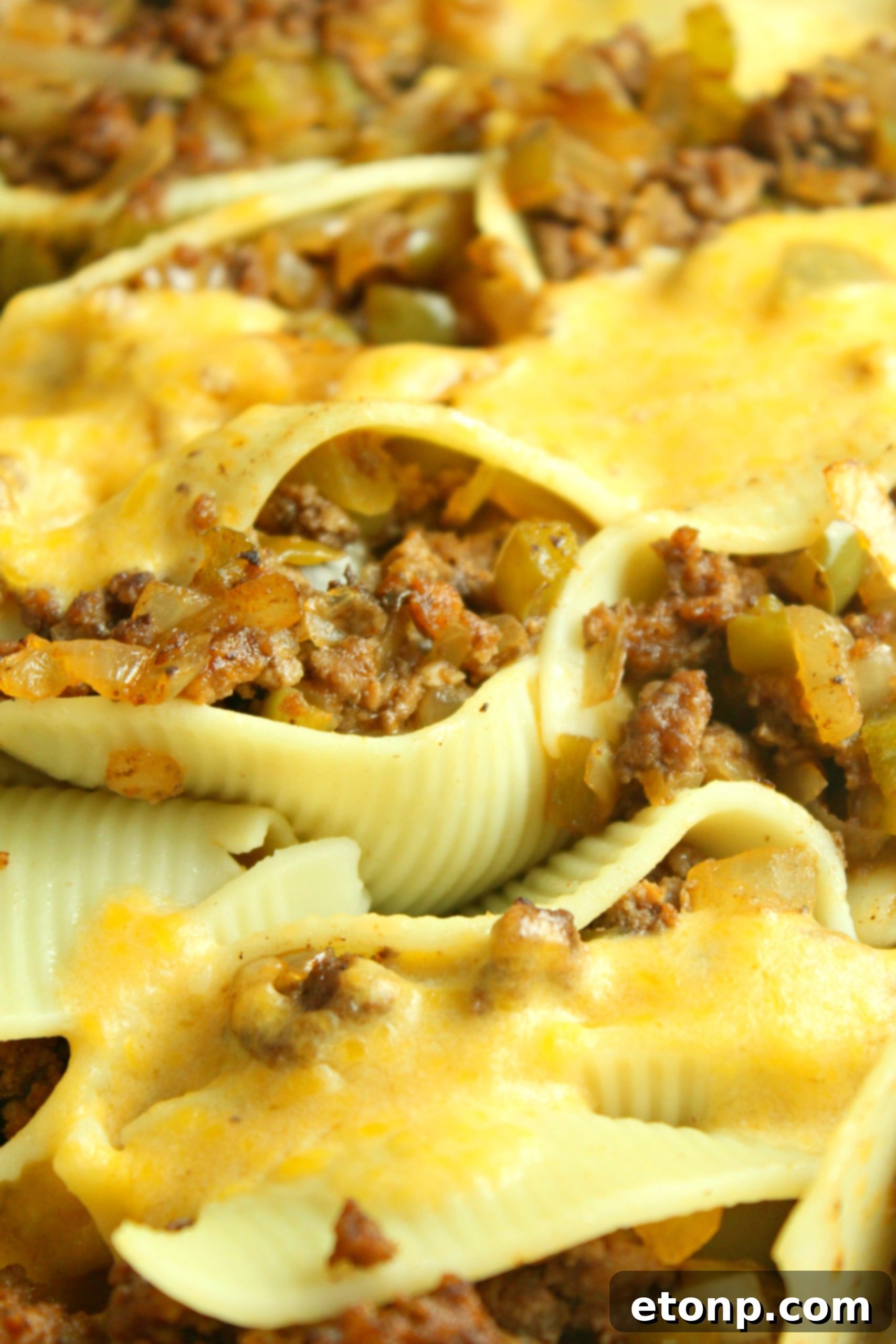 Philly Cheese Steak Stuffed Shells baked to golden perfection in a casserole dish.