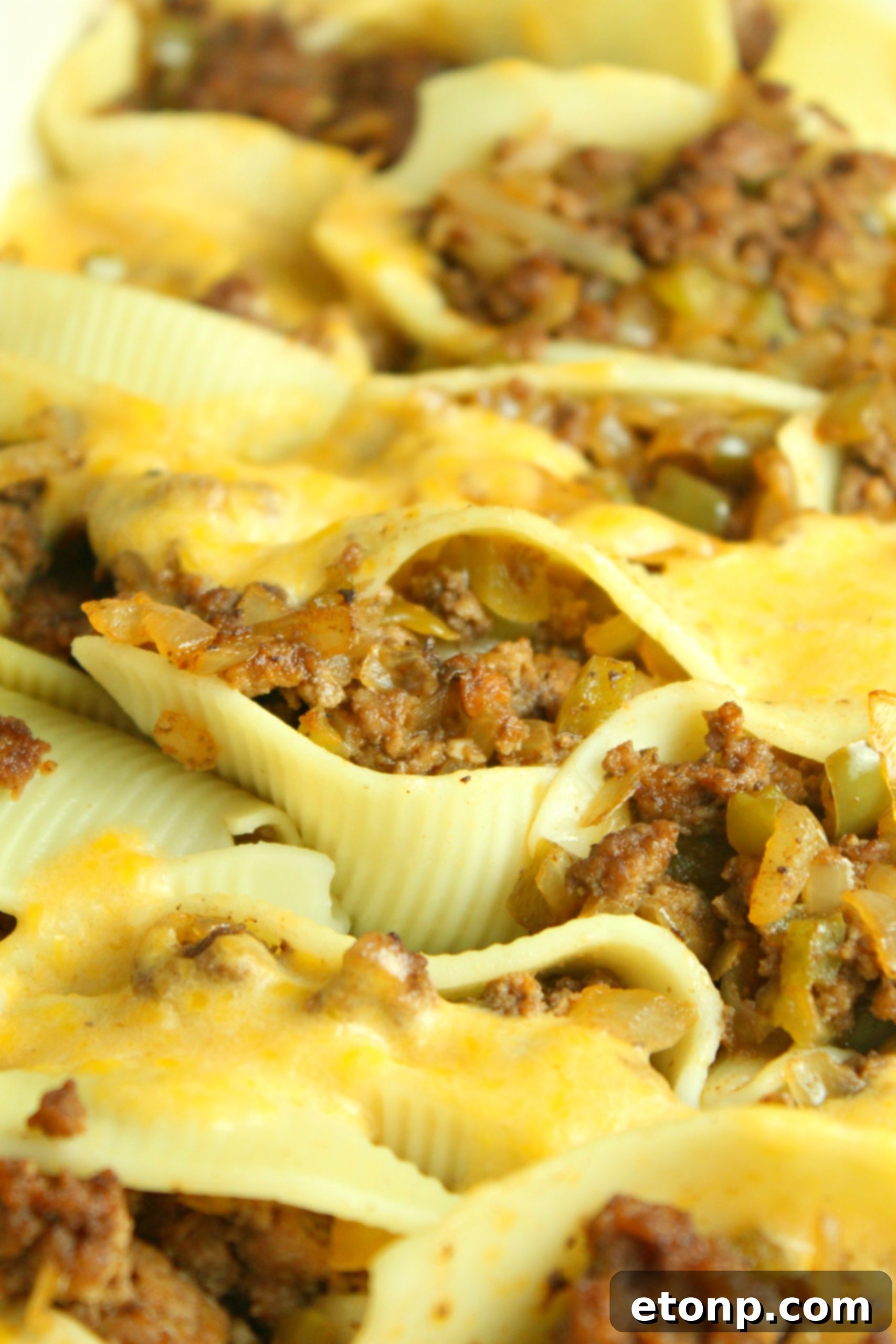 Philly Cheese Steak Stuffed Shells garnished with fresh green onions or chives.