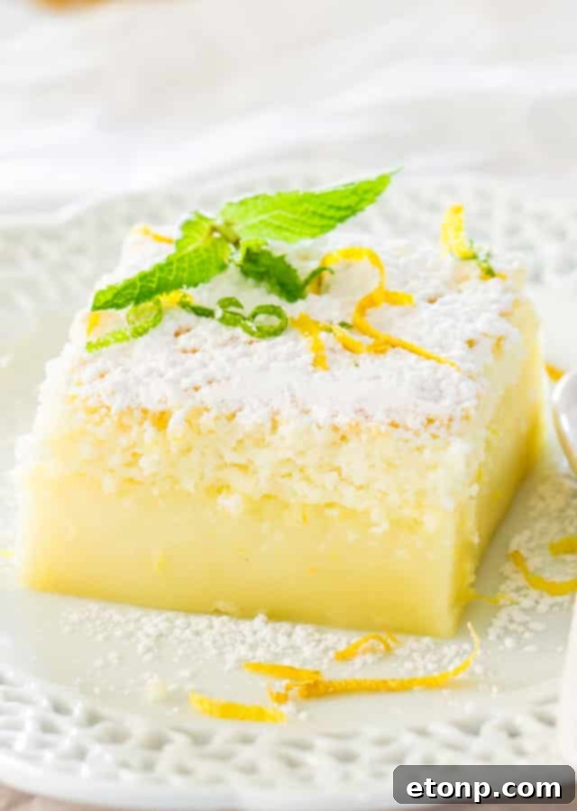 Slice of Lemon Magic Cake showing its distinct three layers
