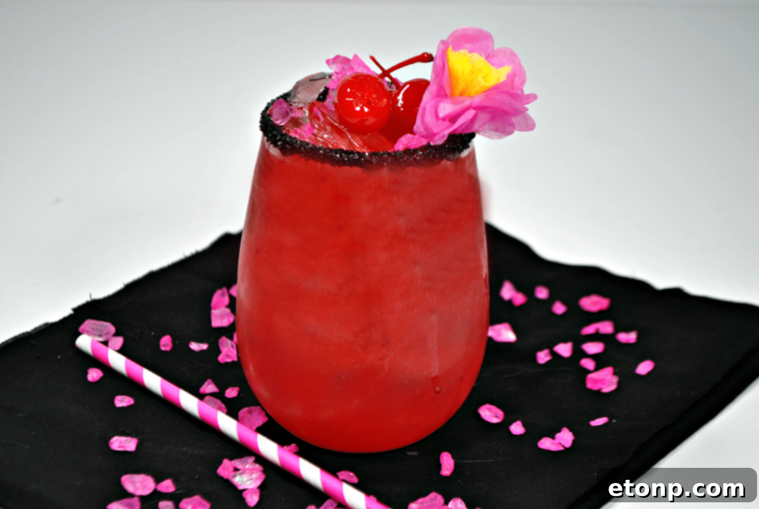 A Barie cocktail in a stylish glass with a lime and cherry garnish, showcasing its photogenic appeal.