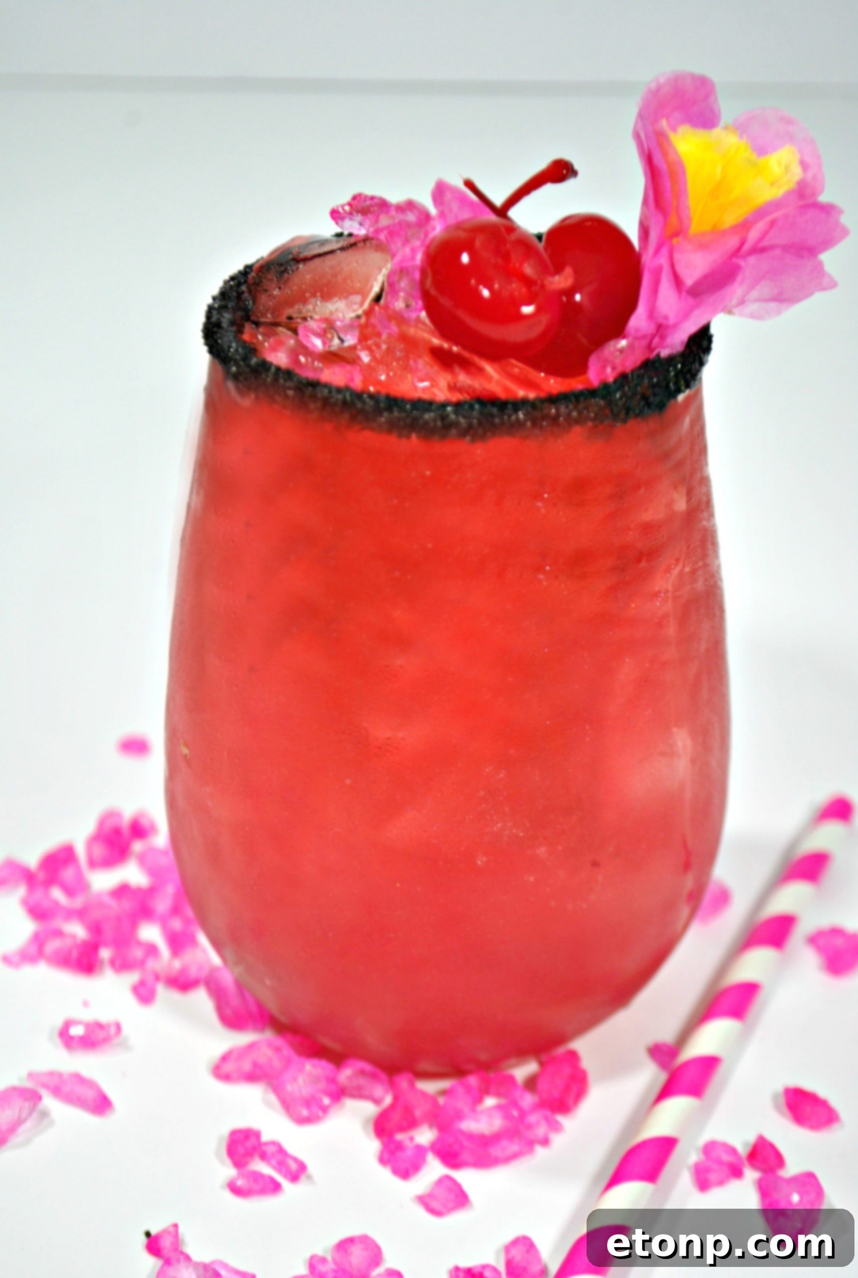 A close-up of the Barbie cocktail's rim with black sprinkles, showcasing the playful and chic detail.