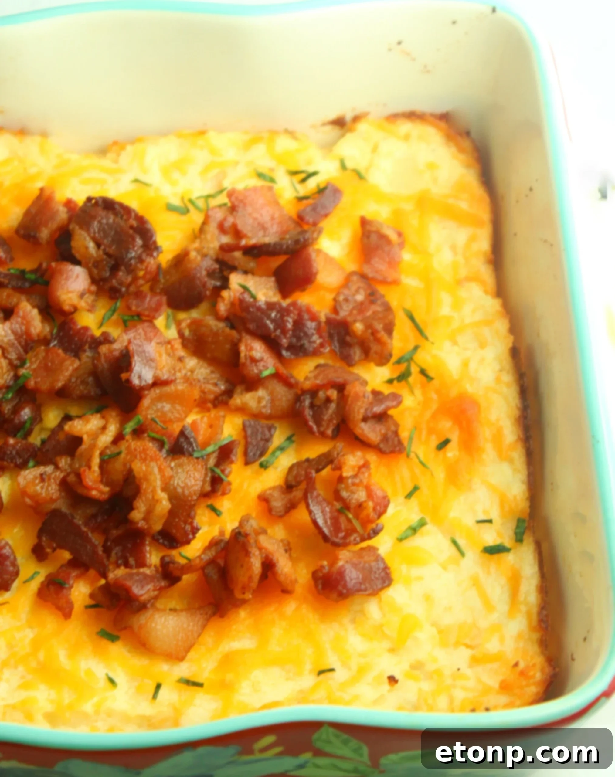 Ultimate Loaded Mashed Potato Casserole 3 Loaded Mashed Potato Casserole in a baking dish, ready to be served, highlighting its rich, golden-brown topping.