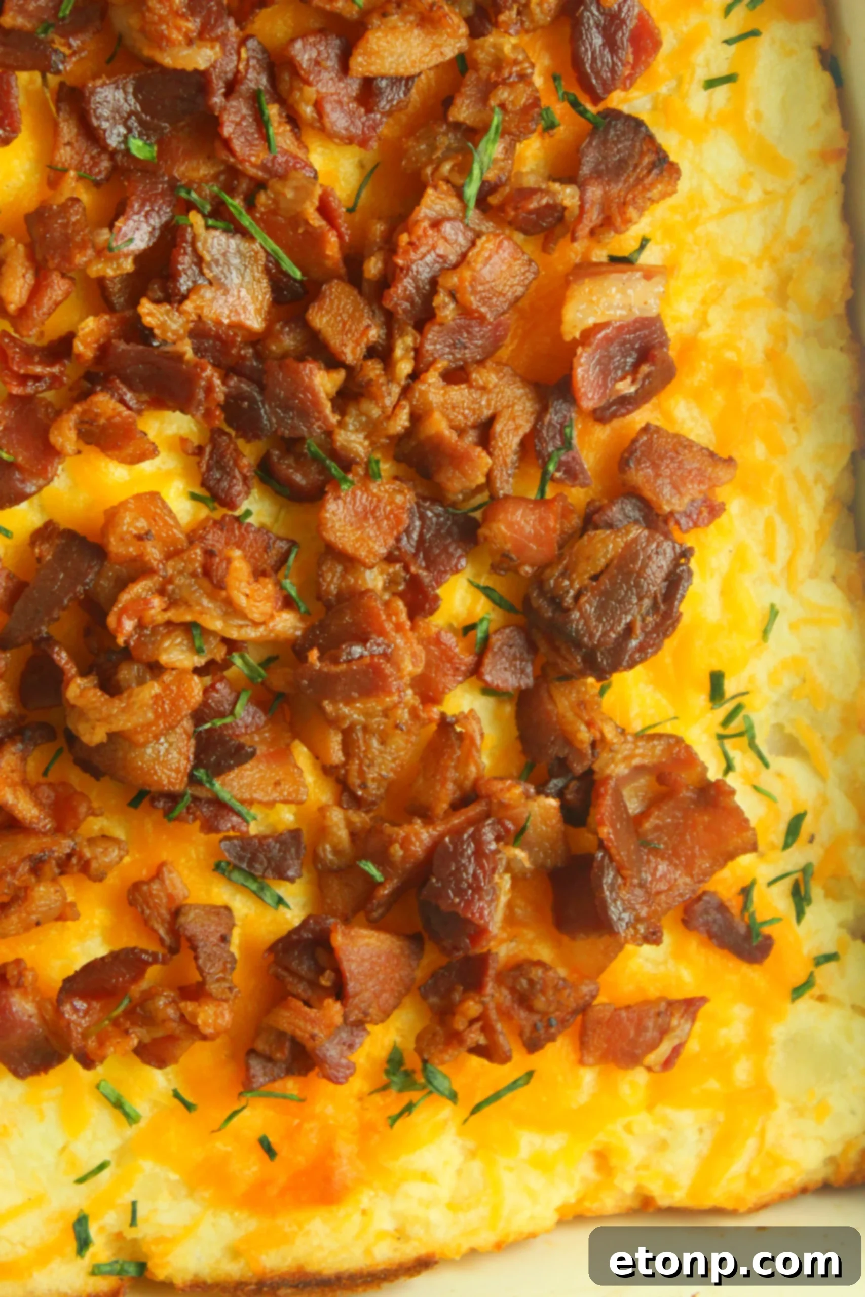 Ultimate Loaded Mashed Potato Casserole 4 A serving of creamy mashed potatoes being transferred into a casserole dish, promising a decadent experience.
