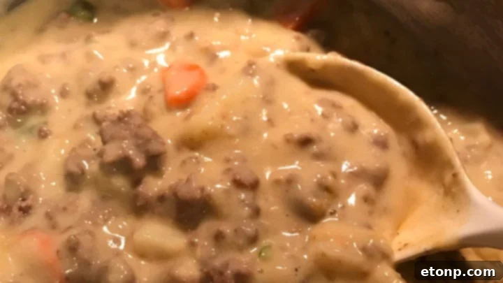 An overhead shot of Slow Cooker Cheeseburger Soup, highlighting the vibrant colors of the ingredients.