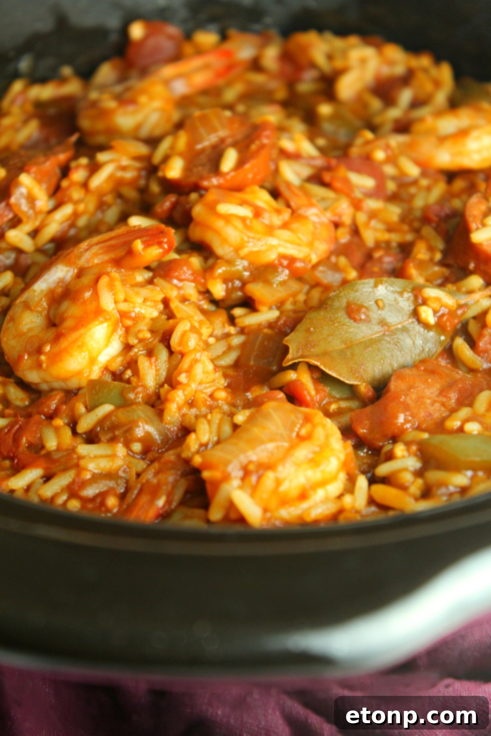 A vibrant bowl of Slow Cooker Jambalaya, showcasing a hearty mix of sausage, shrimp, rice, and vegetables