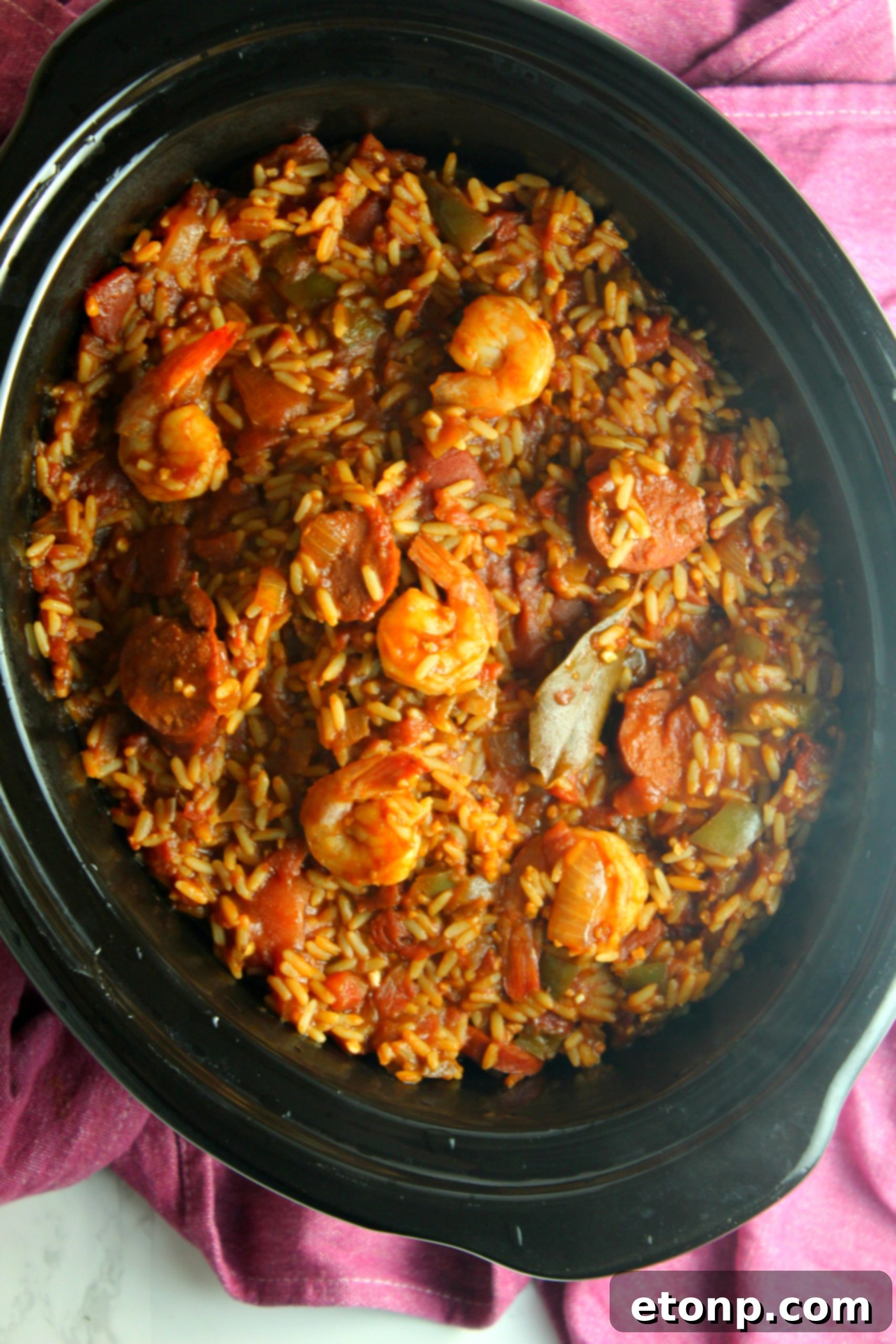 A large pot of Slow Cooker Jambalaya, ready to be served, a perfect example of comforting slow-cooked meal