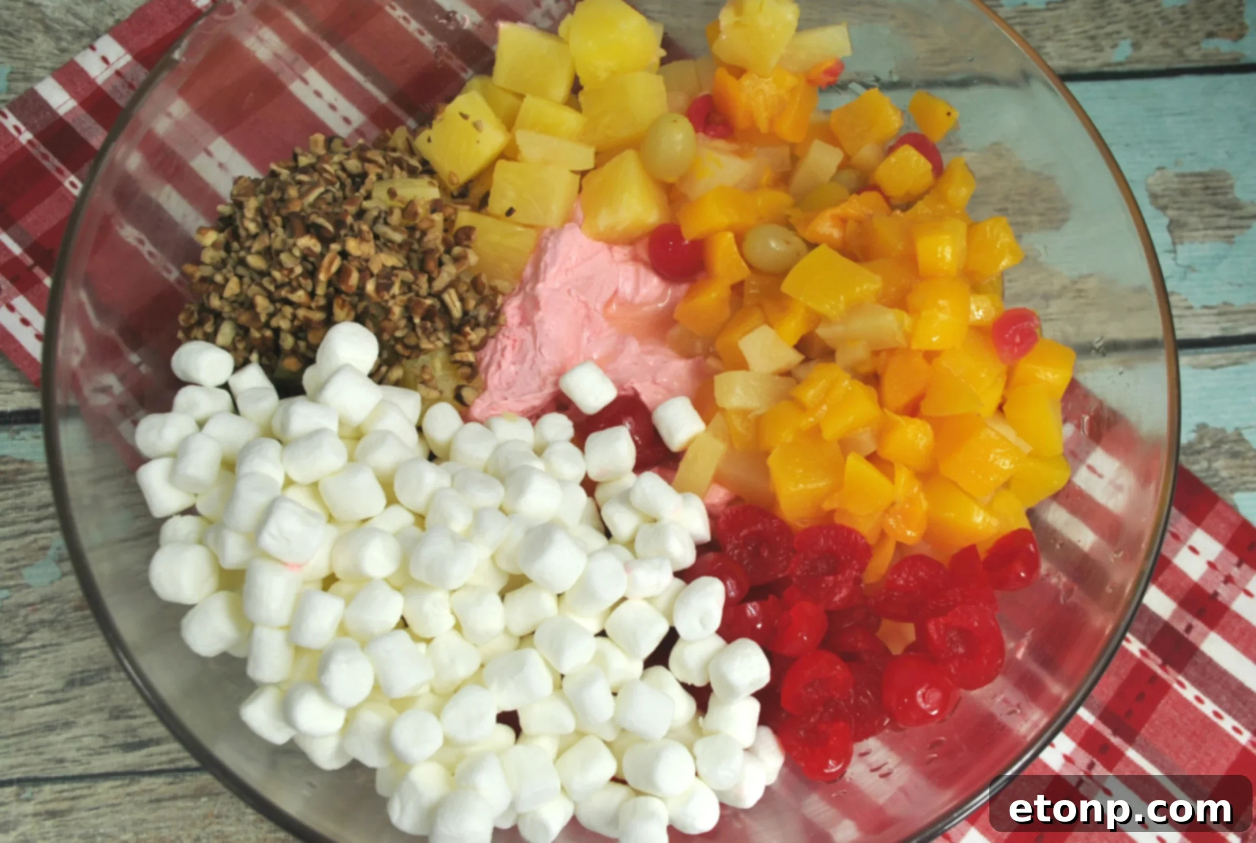 Close-up of Cherry Fluff Salad in a white bowl, showing its creamy texture and visible cherries.