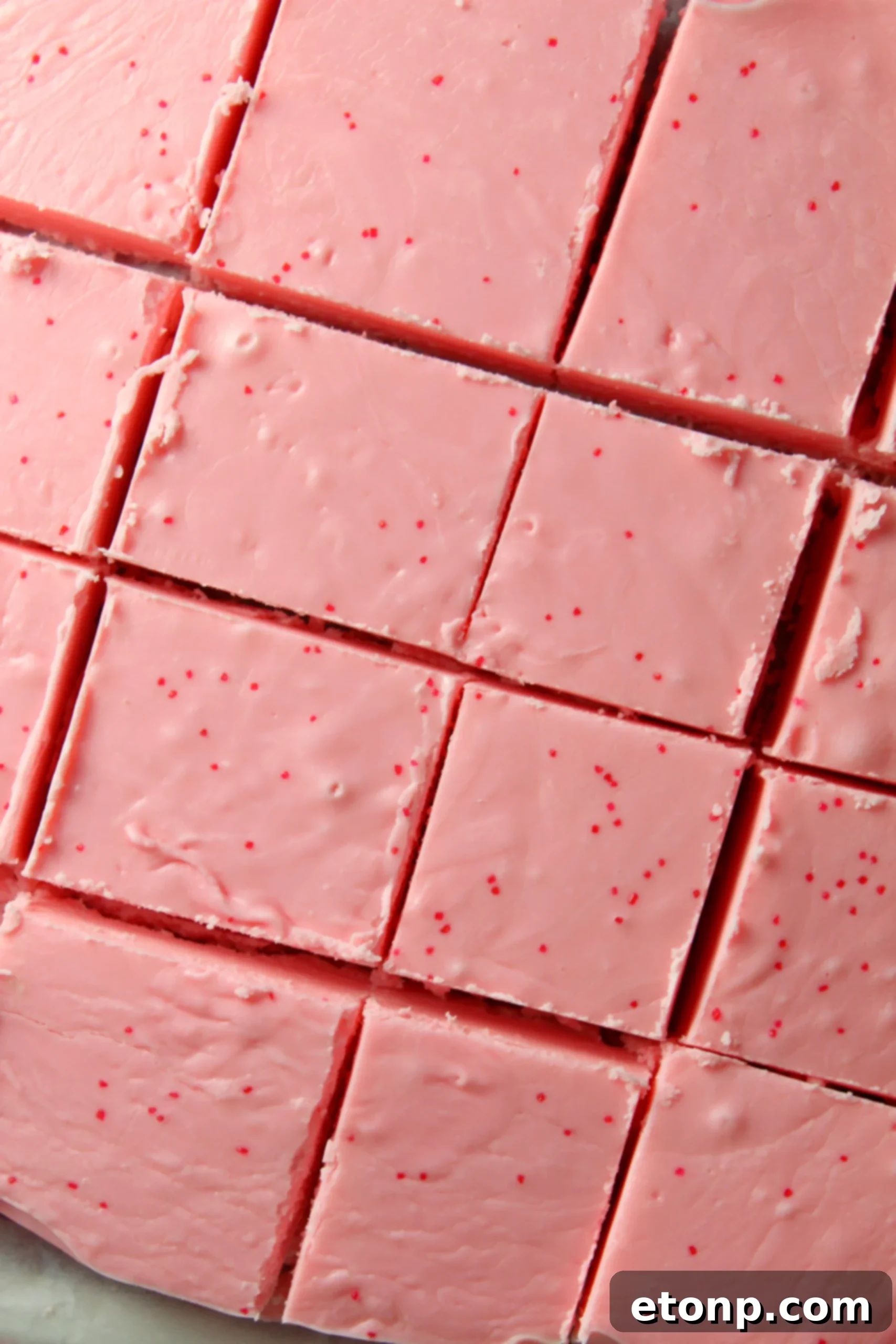 Effortless Strawberry Two-Ingredient Fudge 5 Stack of strawberry no-bake fudge with sprinkles