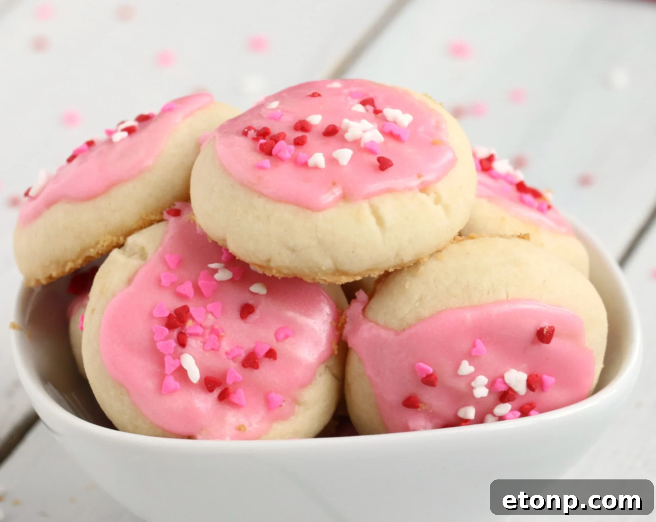 Velvet Vanilla Frosted Delights 2 Melt-Away Vanilla Frosted Cookies arranged beautifully on a plate, ready to be served.