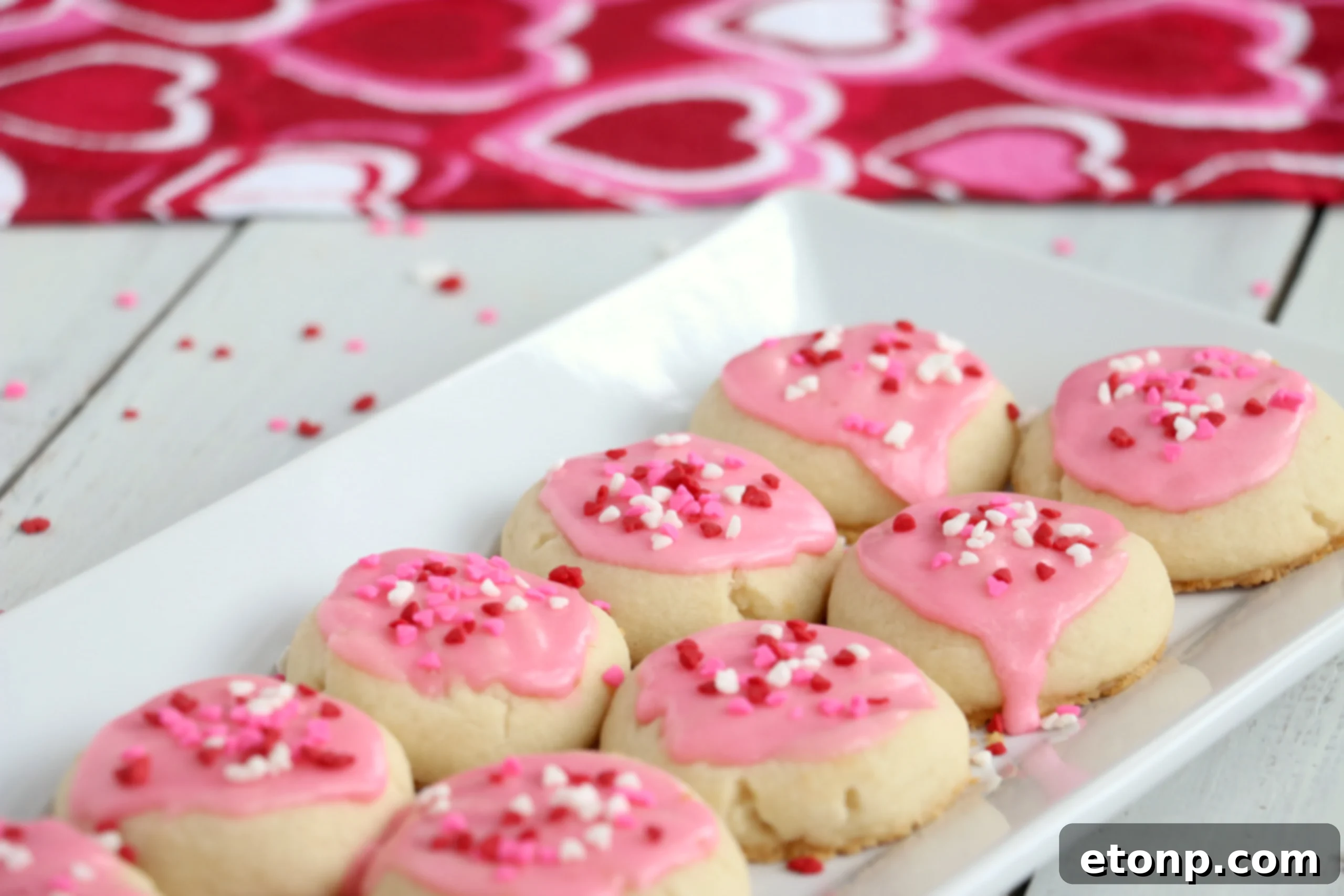 Velvet Vanilla Frosted Delights 7 A stack of three Melt-Away Vanilla Frosted Cookies, highlighting their soft texture and generous frosting.