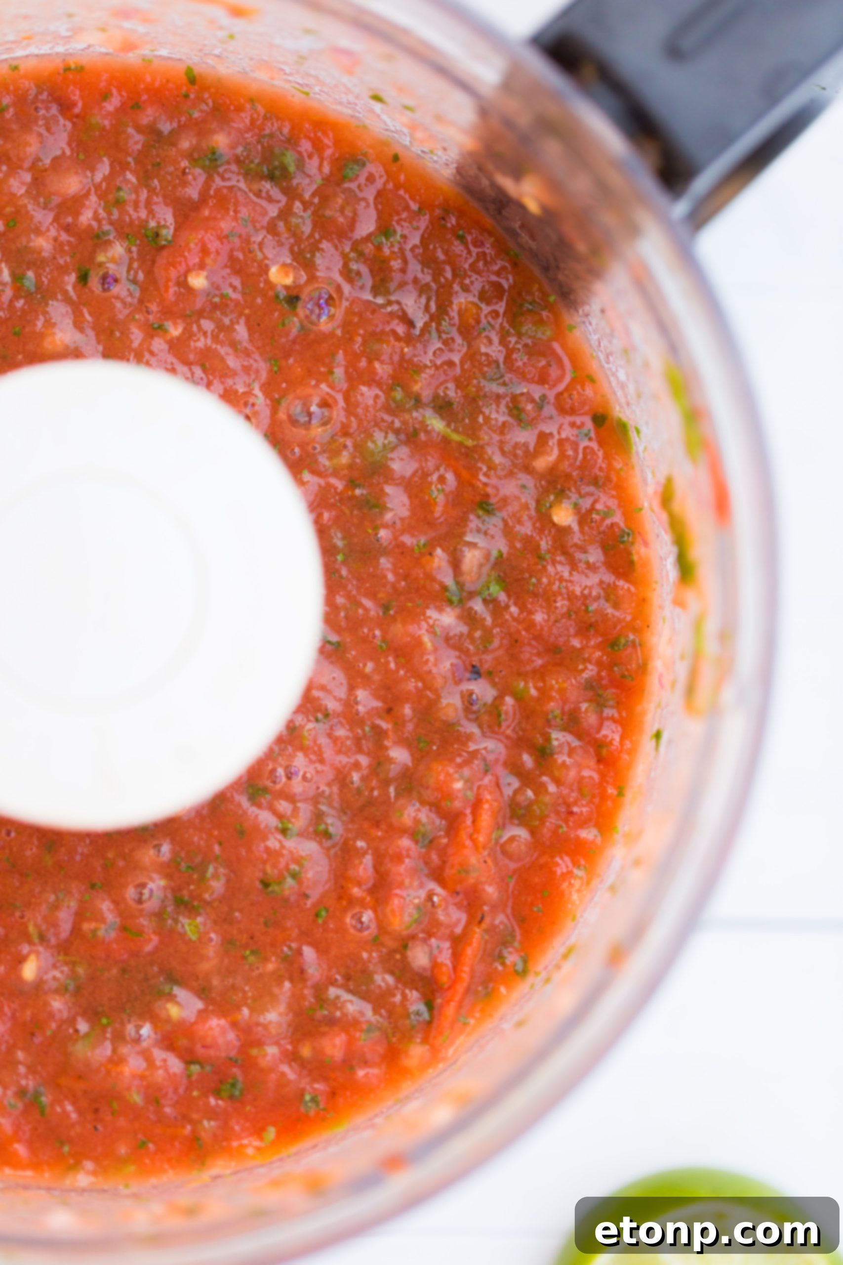 A high-speed blender filled with fresh salsa ingredients, showcasing the ease of preparation for homemade restaurant-style salsa.