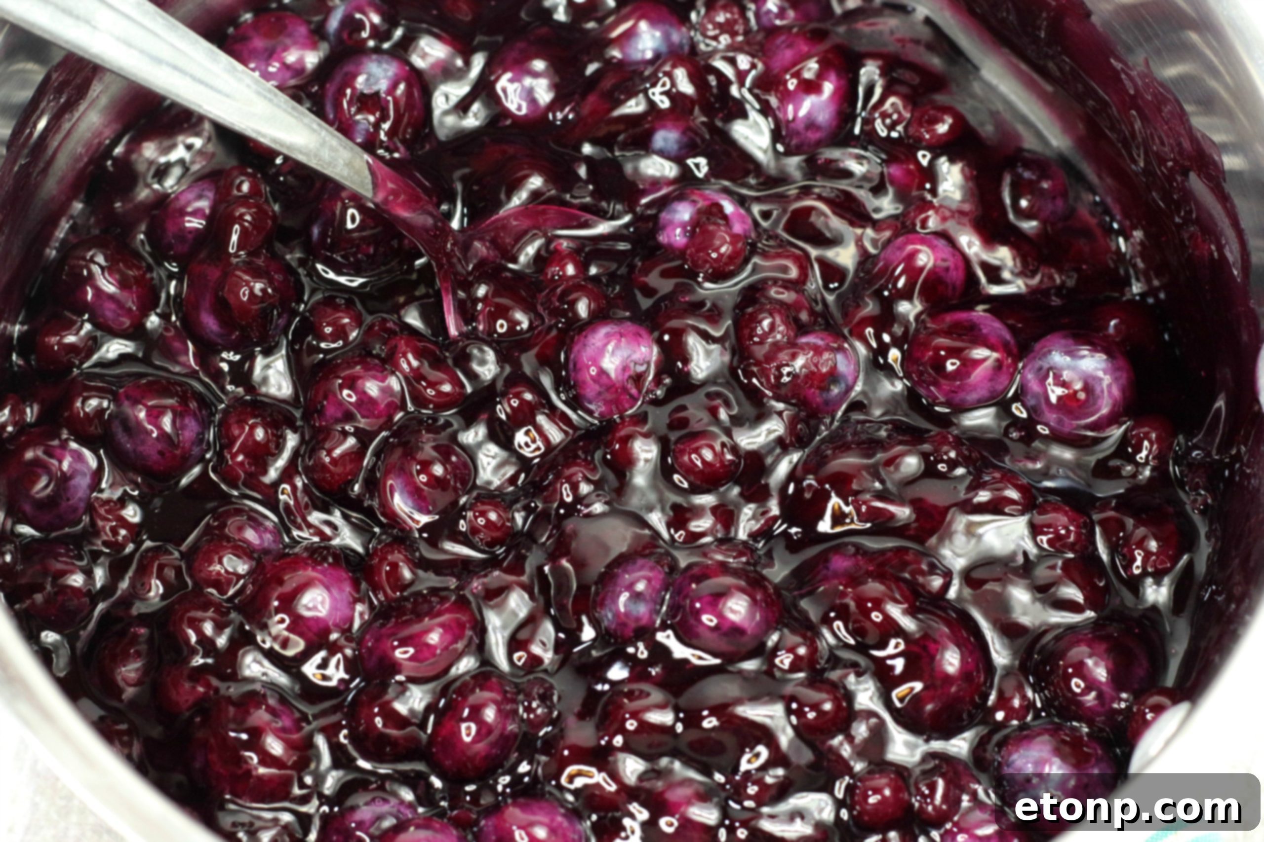 Close-up of the juicy blueberry pie filling being prepared in a saucepan